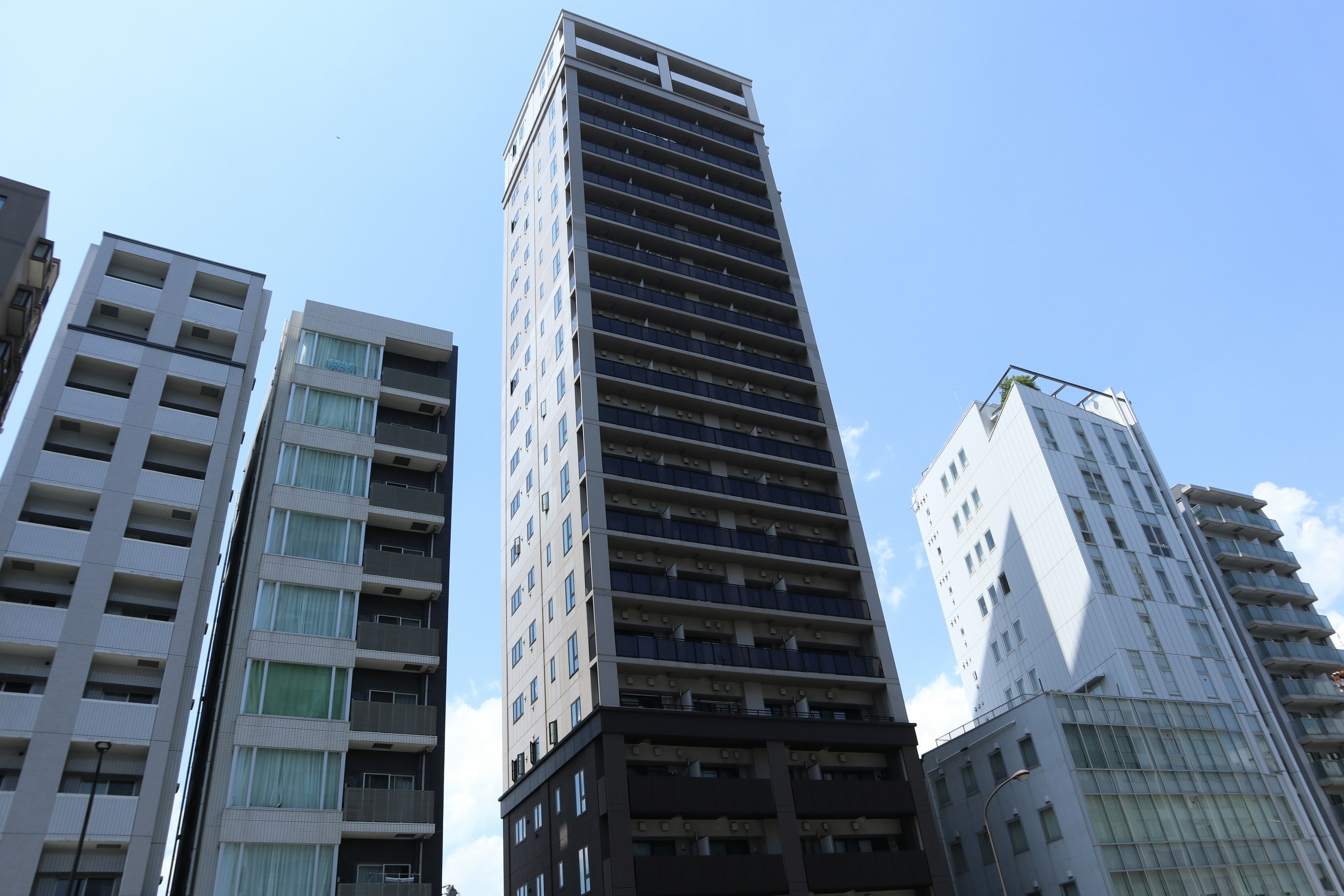 Tall black building among modern skyscrapers