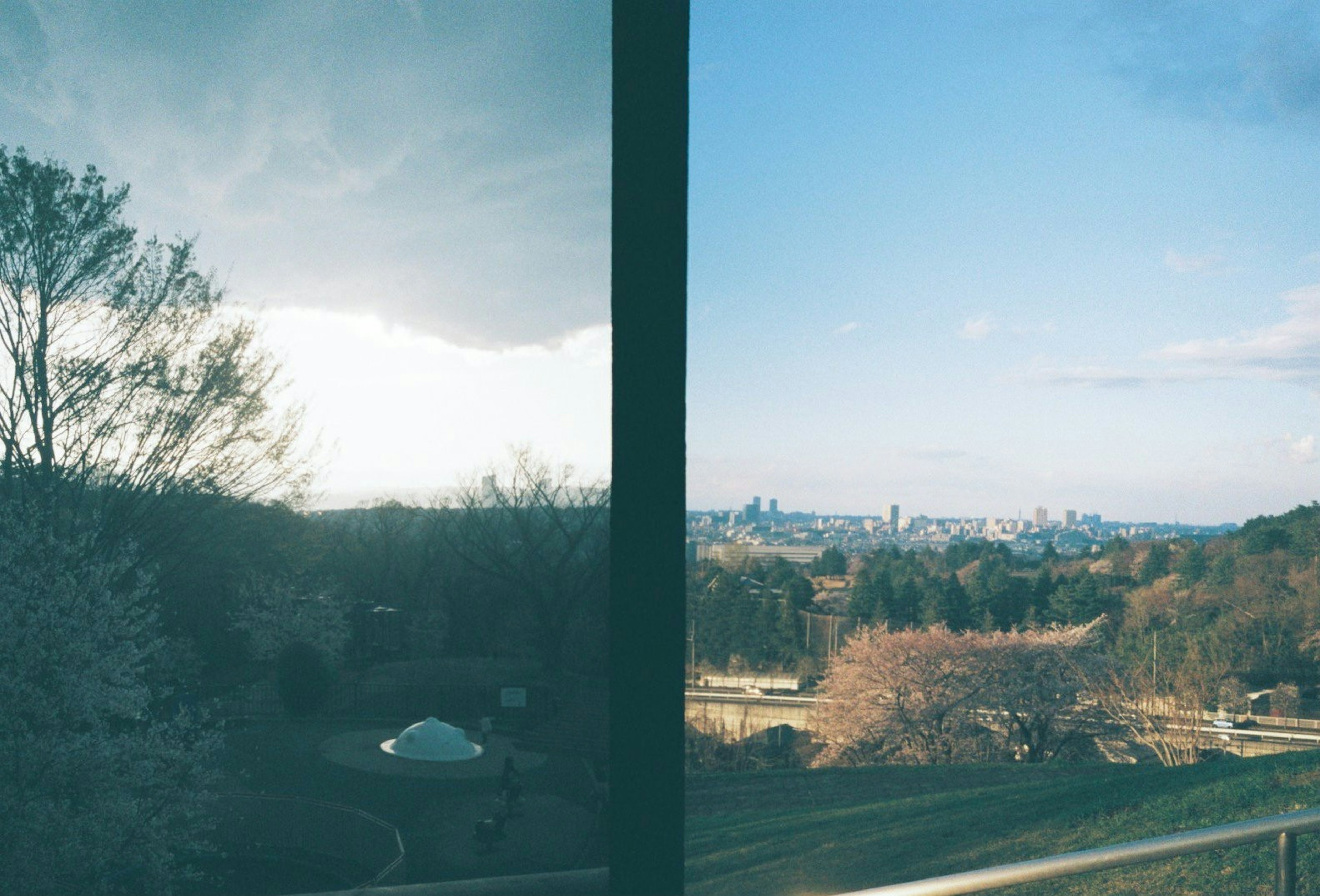 Left side shows cloudy landscape right side features sunny city view