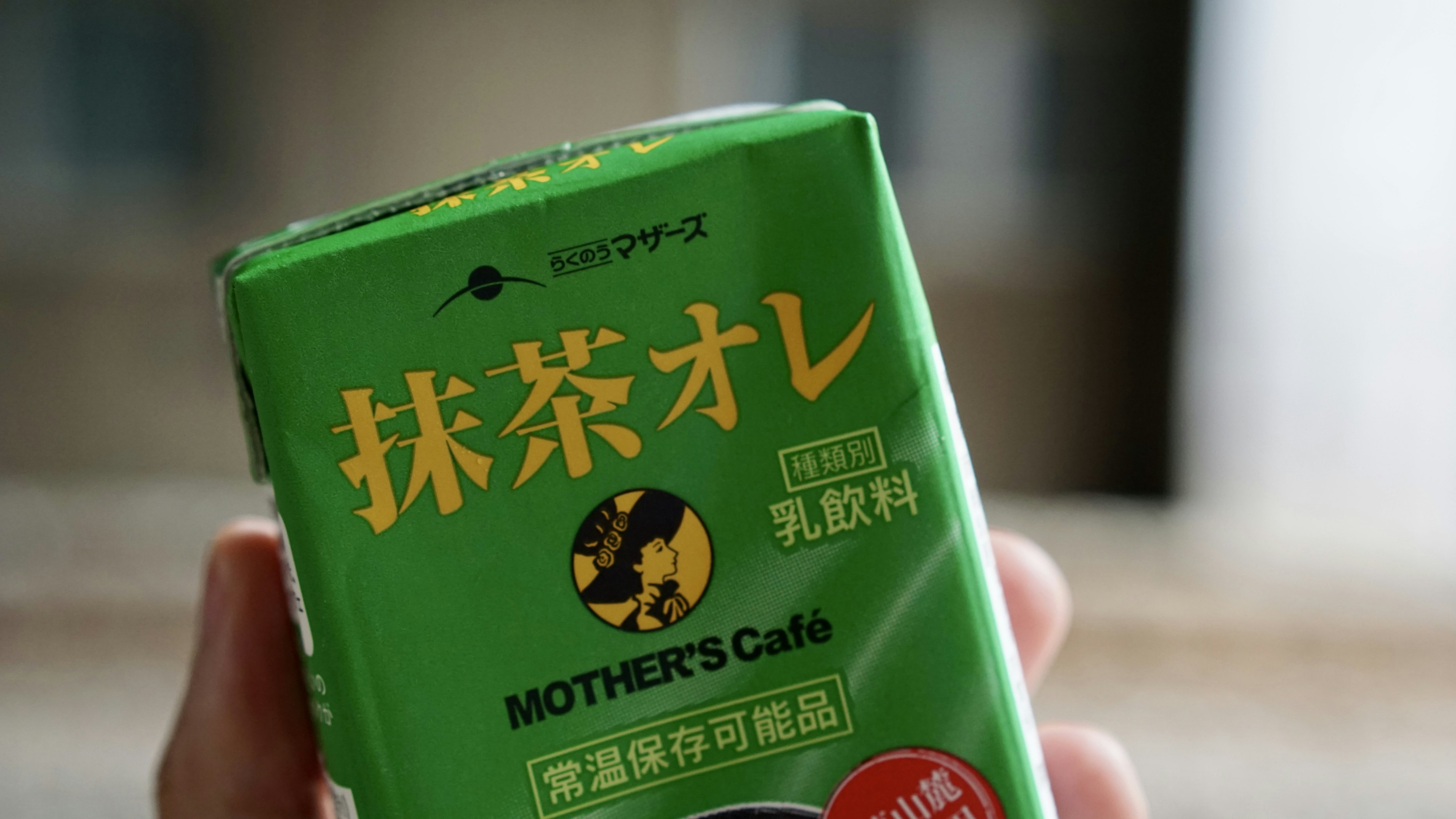 Green matcha latte package held in hand