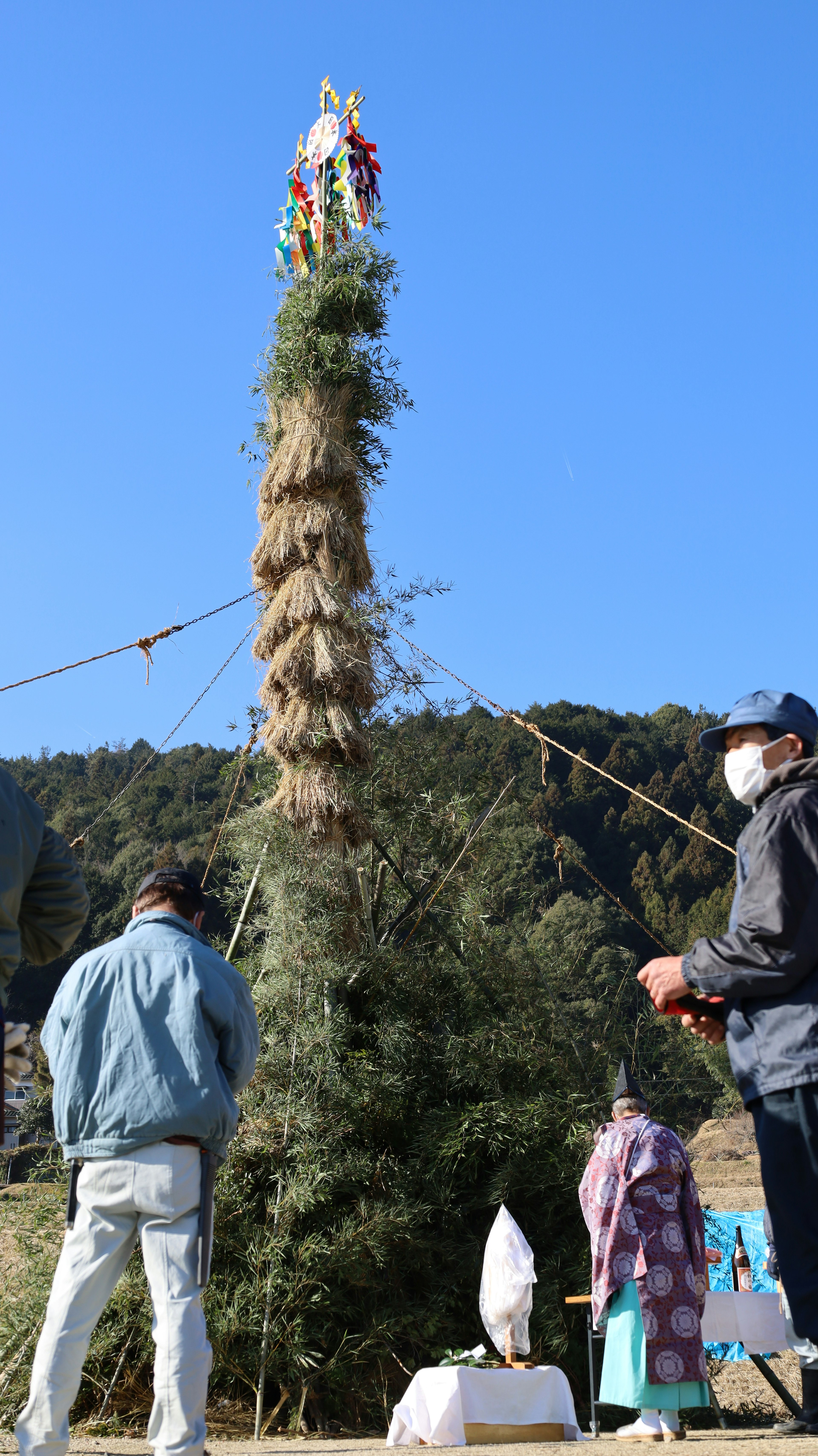 Tall grass tower with people gathered around