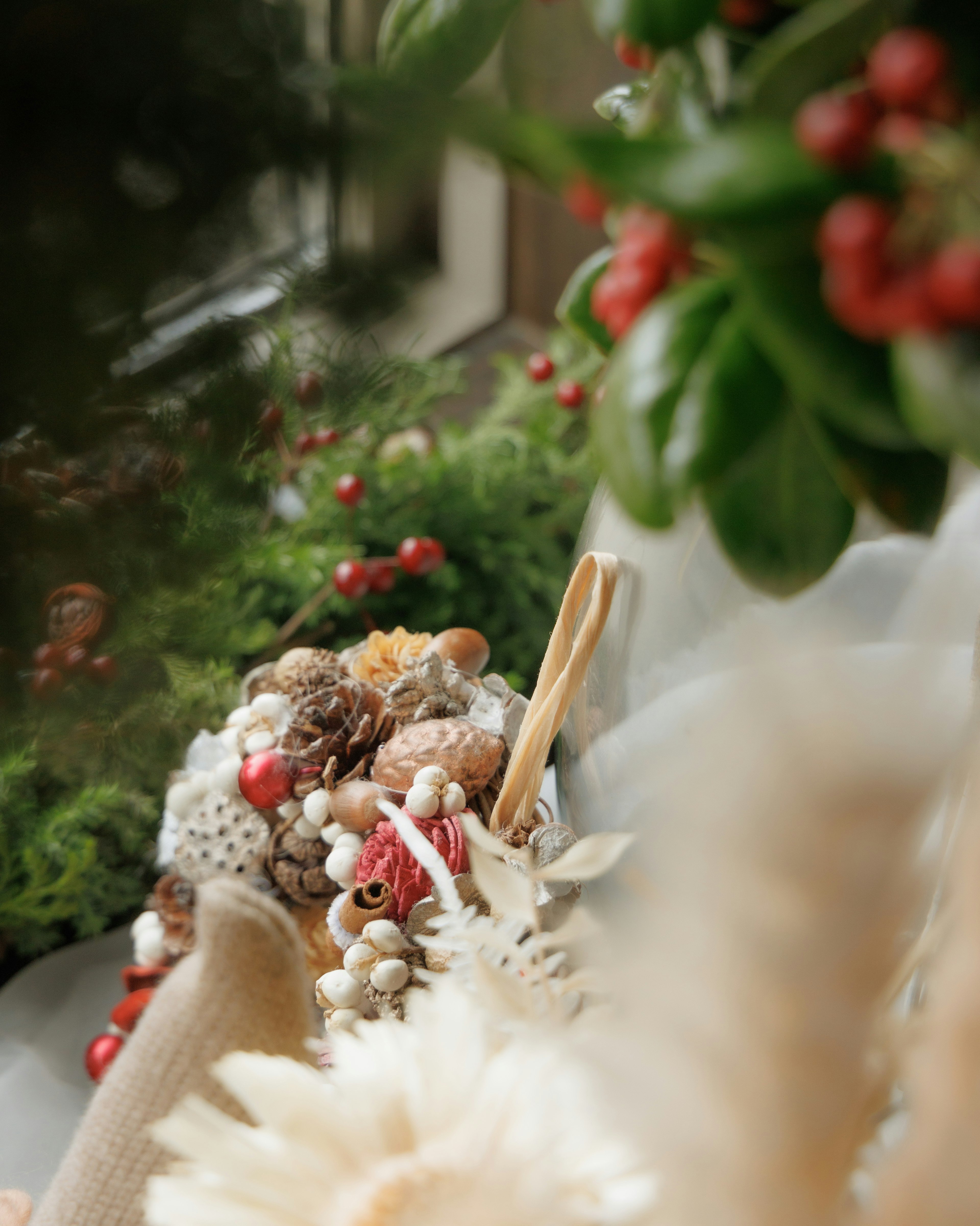 A serene scene featuring an arrangement of dried flowers and greenery with red berries