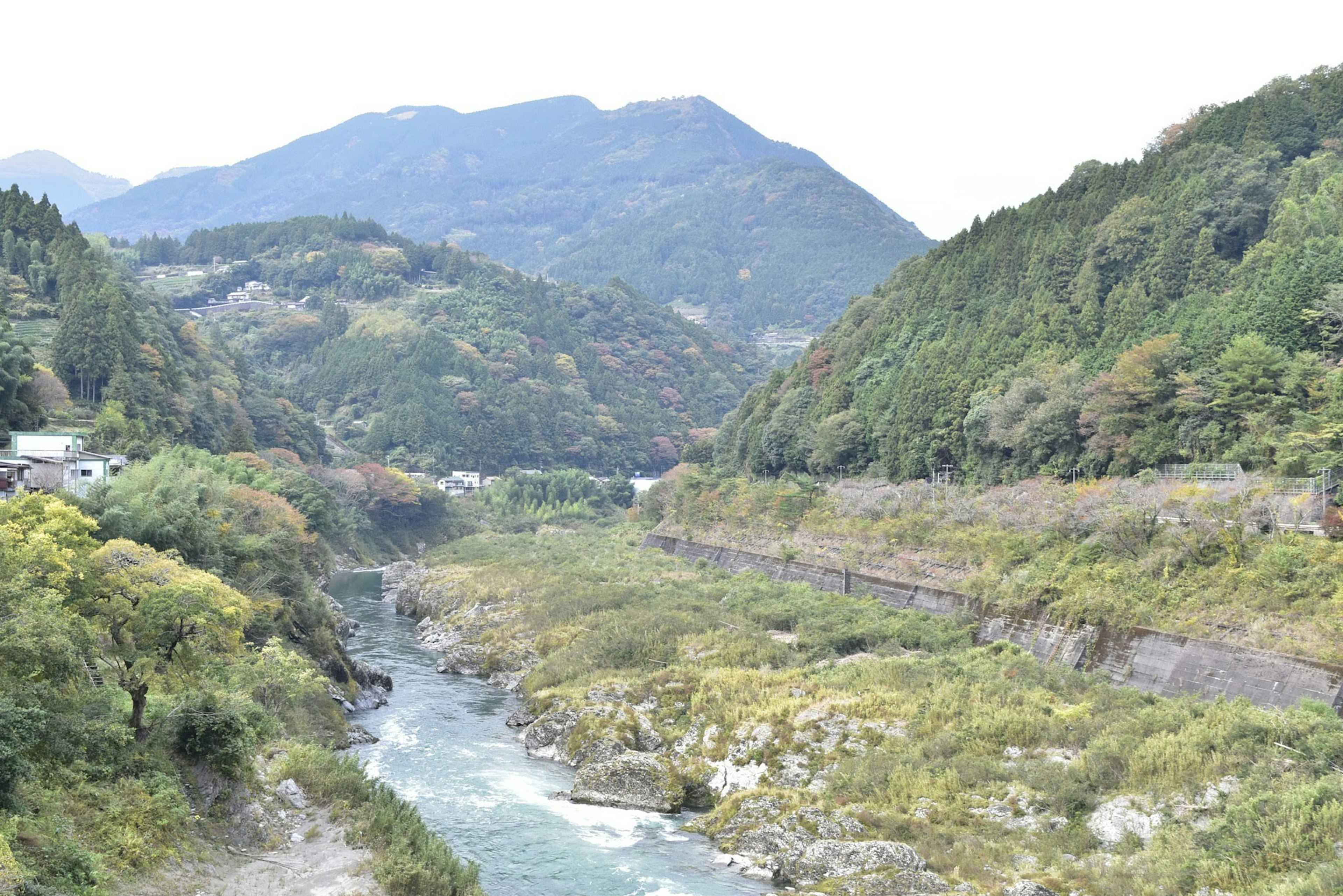 Scenic view of mountains and river lush greenery