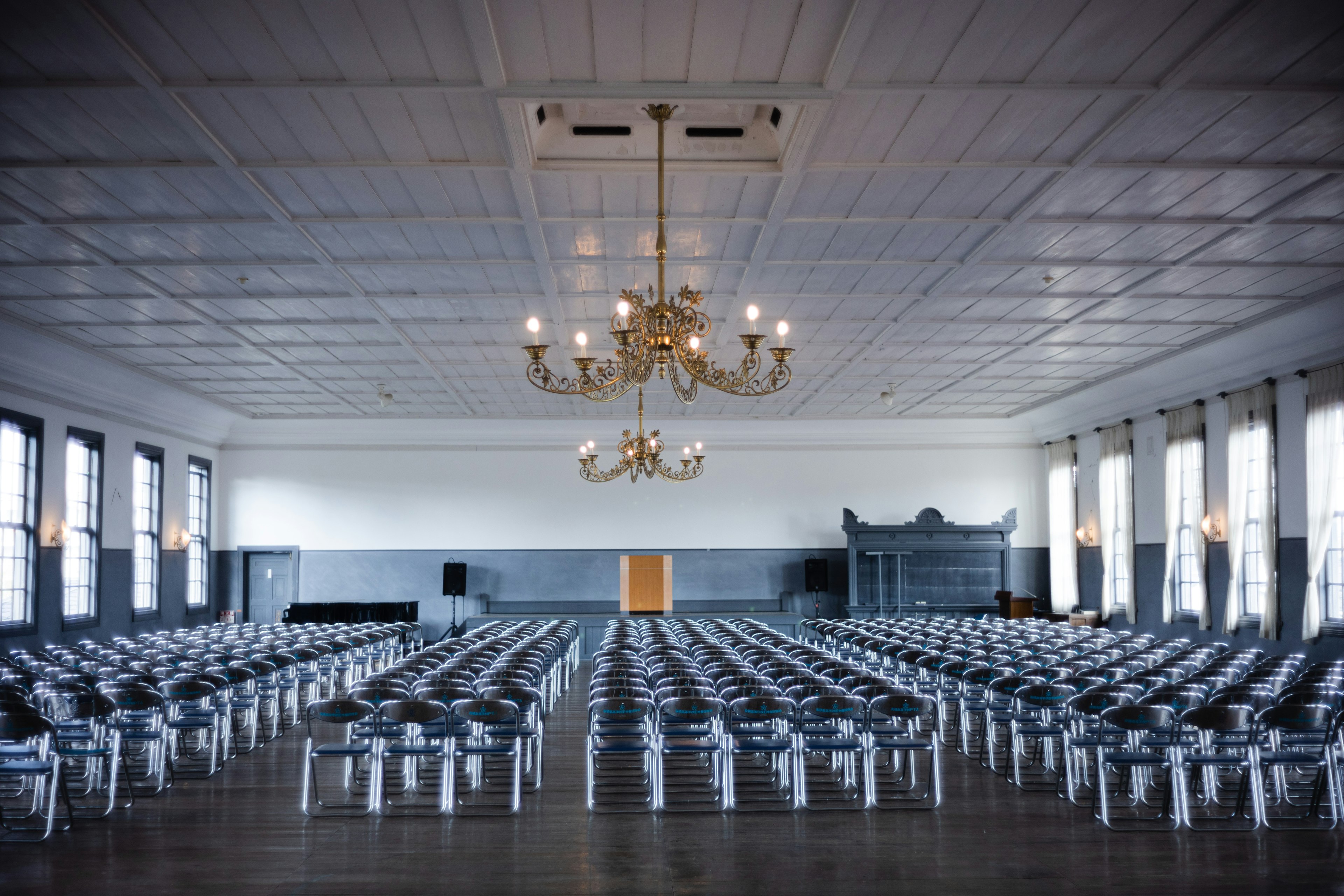 Spacious conference room with neatly arranged chairs and chandelier