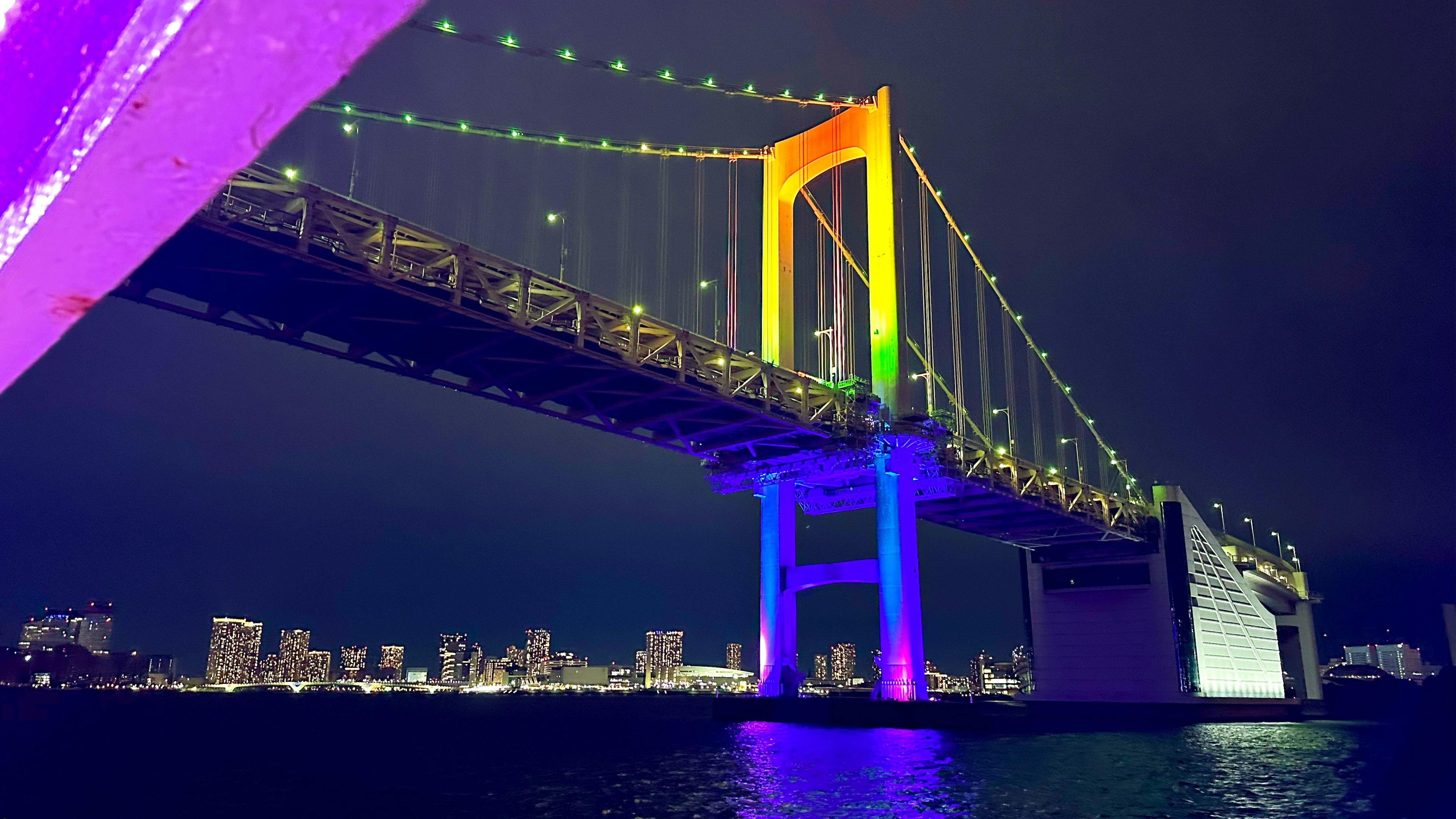 Rainbow Bridge at night with colorful lighting