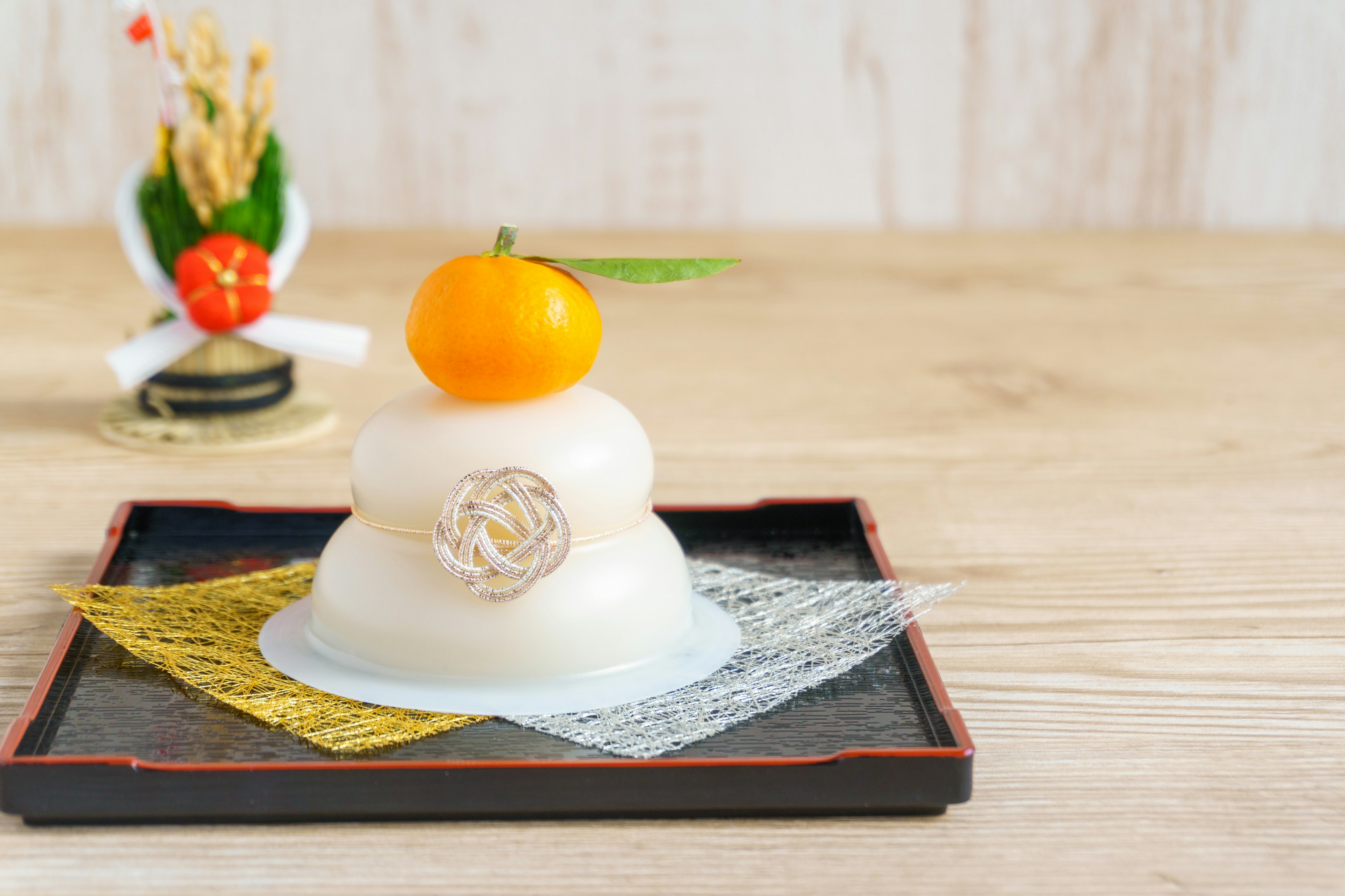 A beautifully arranged Japanese sweet with a mandarin orange on top