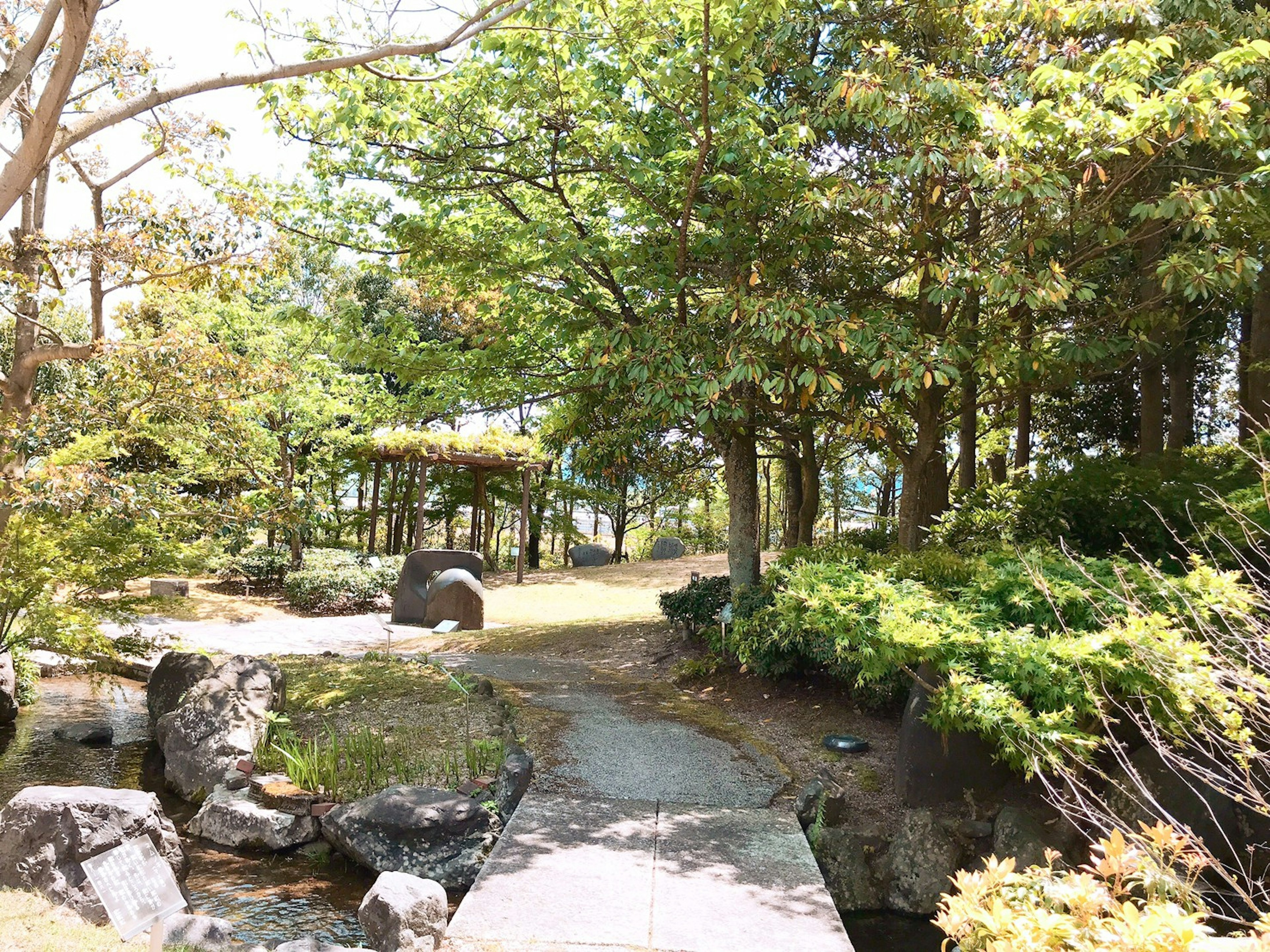 緑豊かな庭園に続く石の小道と木々の間にある風景