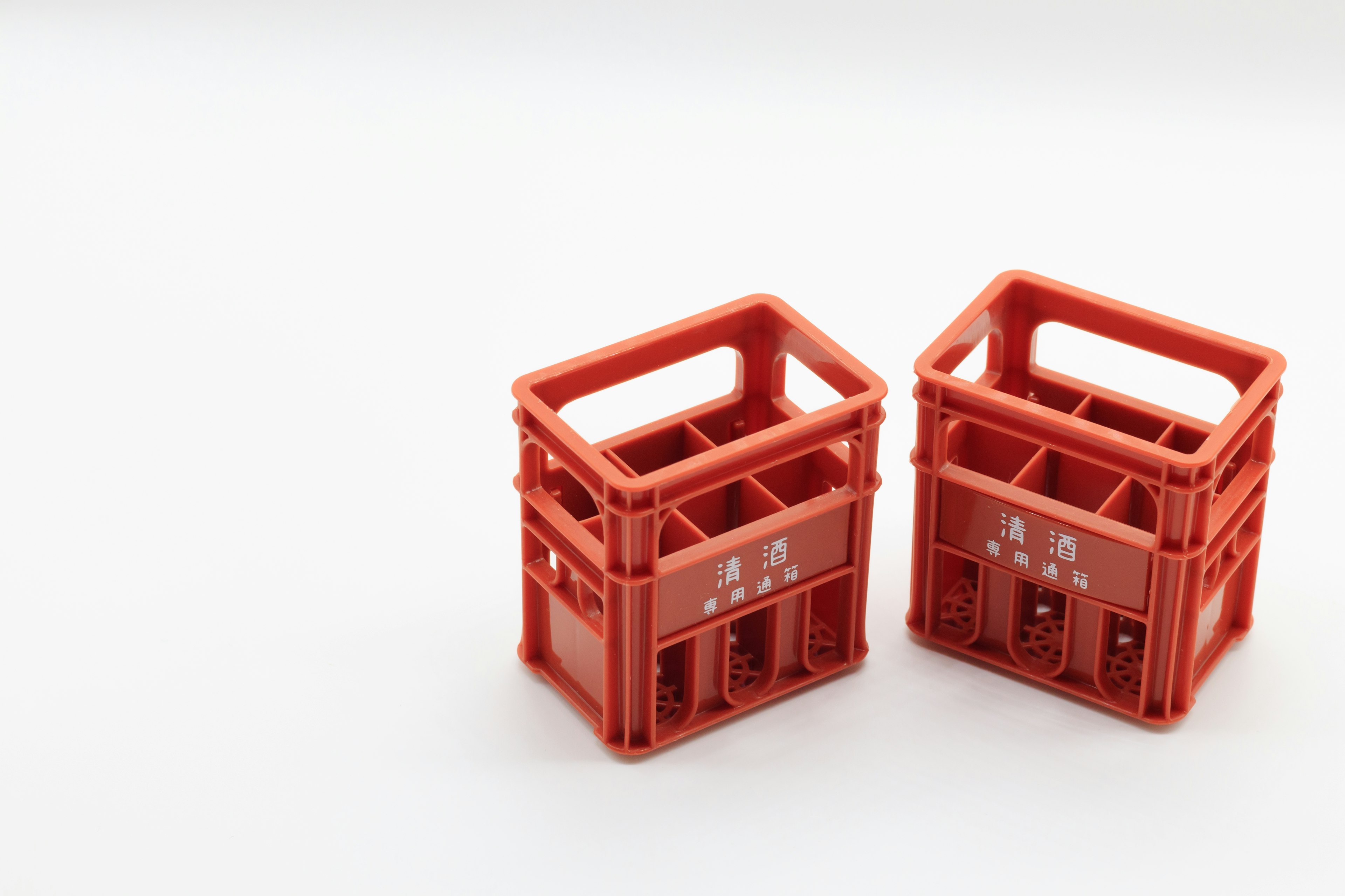 Two red plastic crates positioned side by side