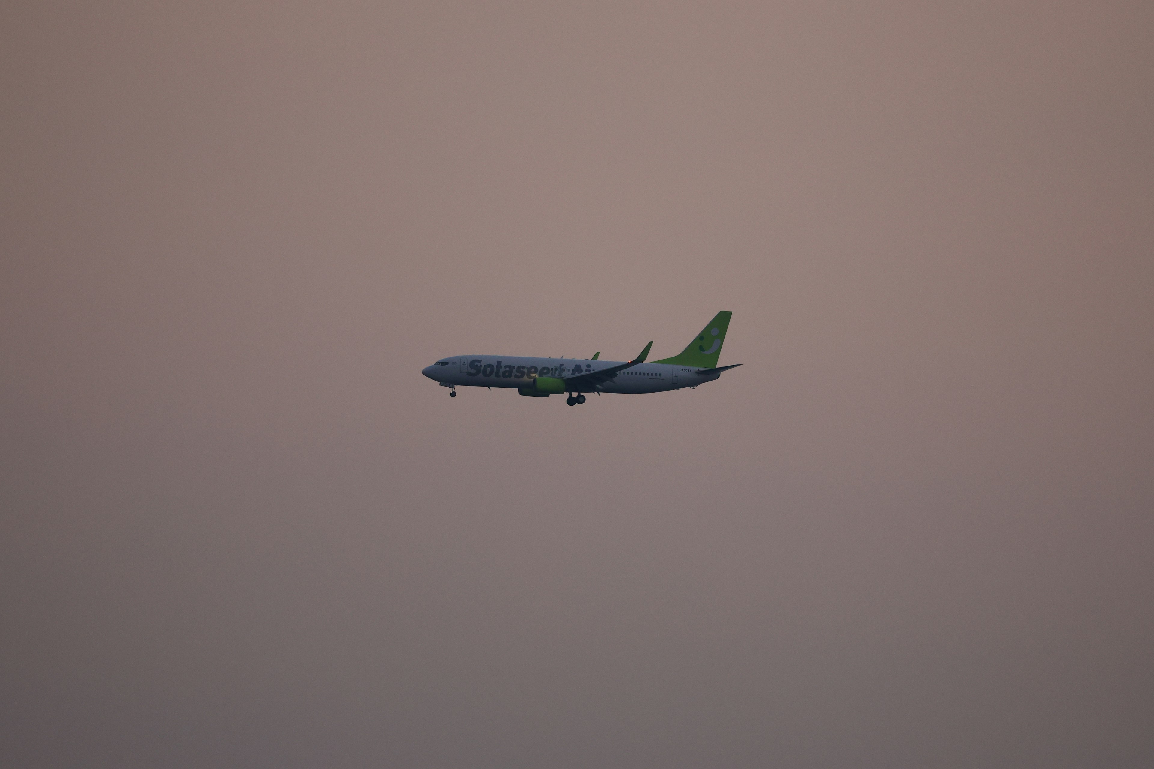 Silhouette of an aircraft flying during twilight