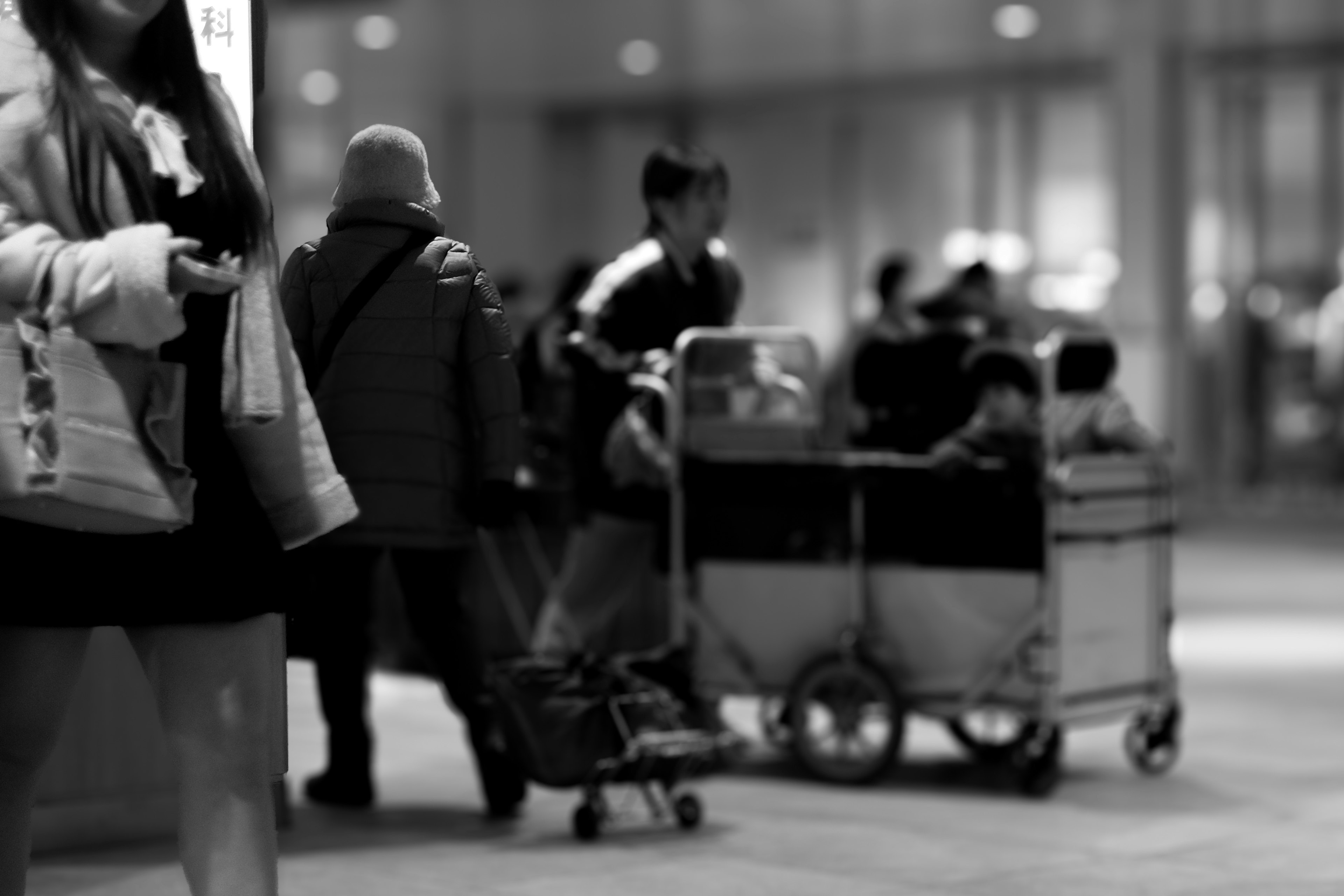 A bustling urban scene with people and carts