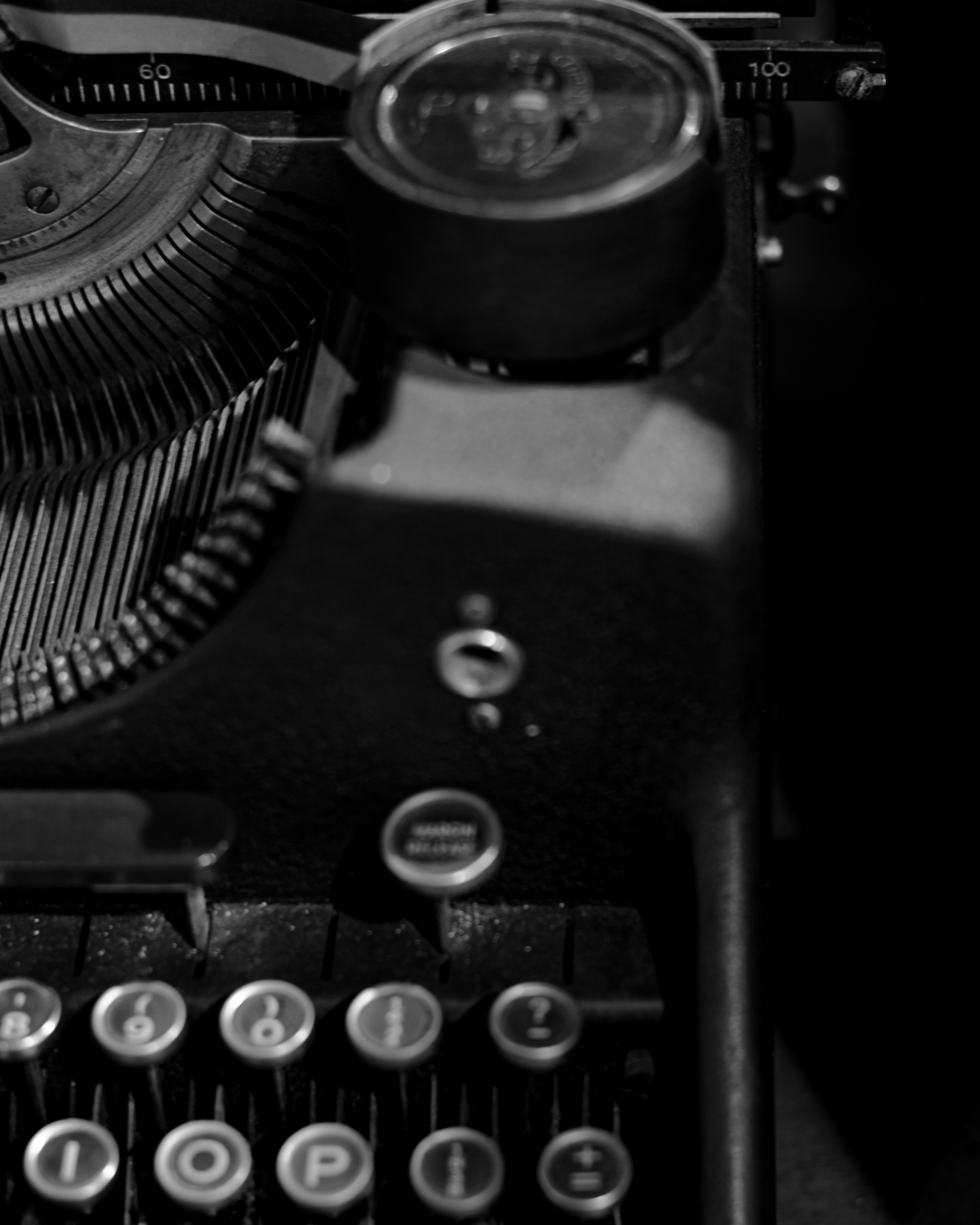 Close-up of an old typewriter showing keys and a gauge