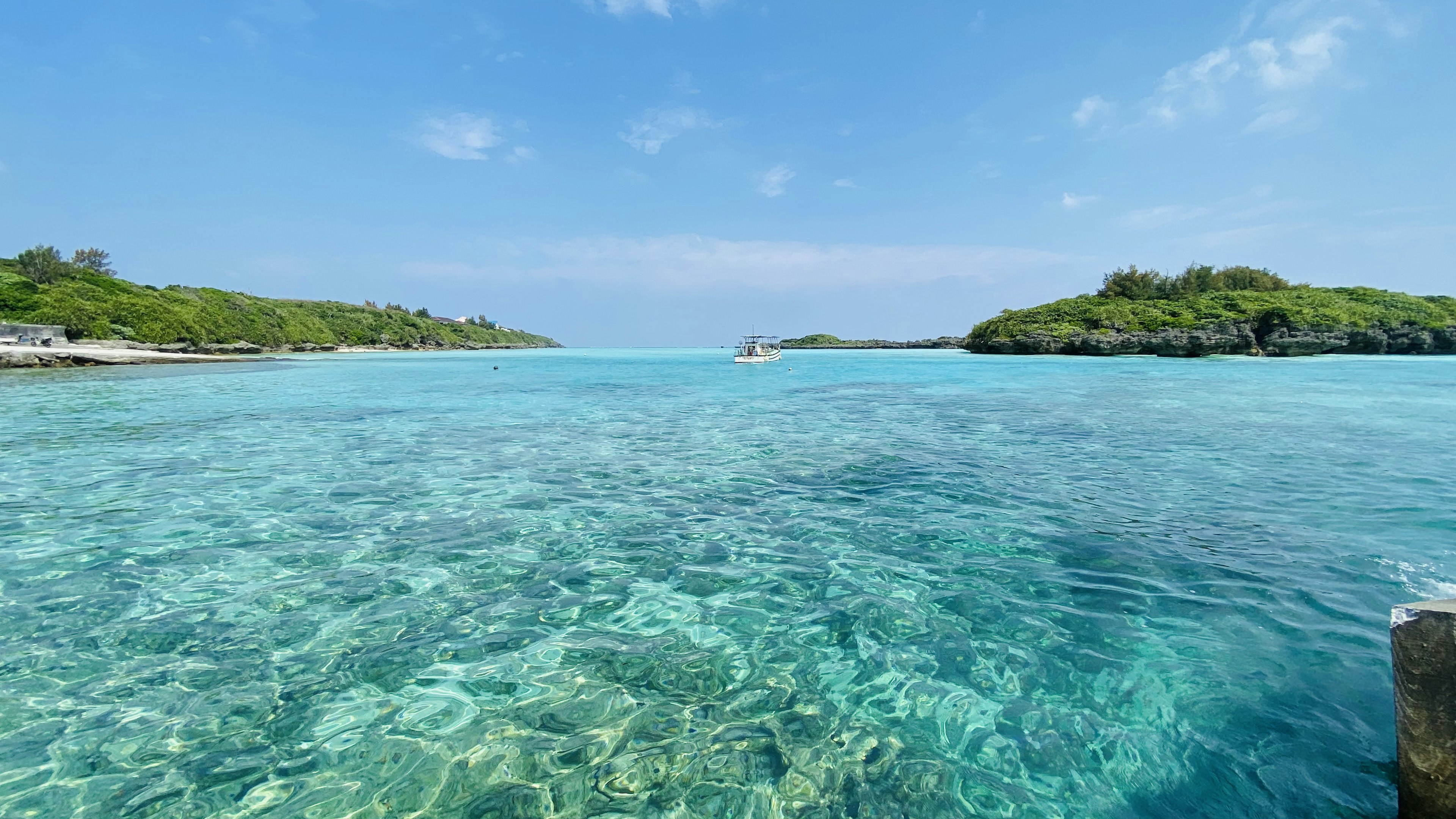 Clear blue ocean with green islands in the background