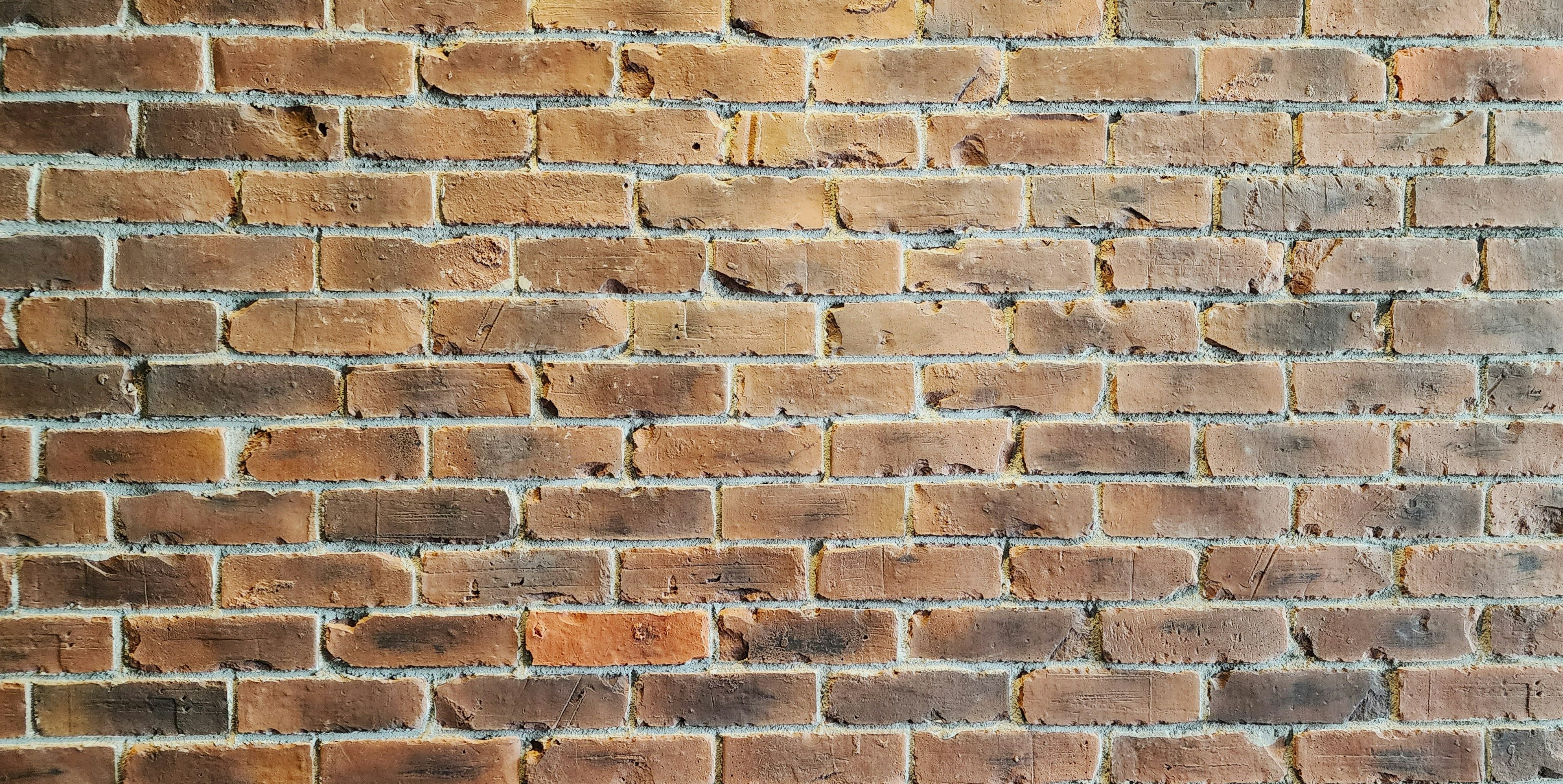 Textured red-brown brick wall