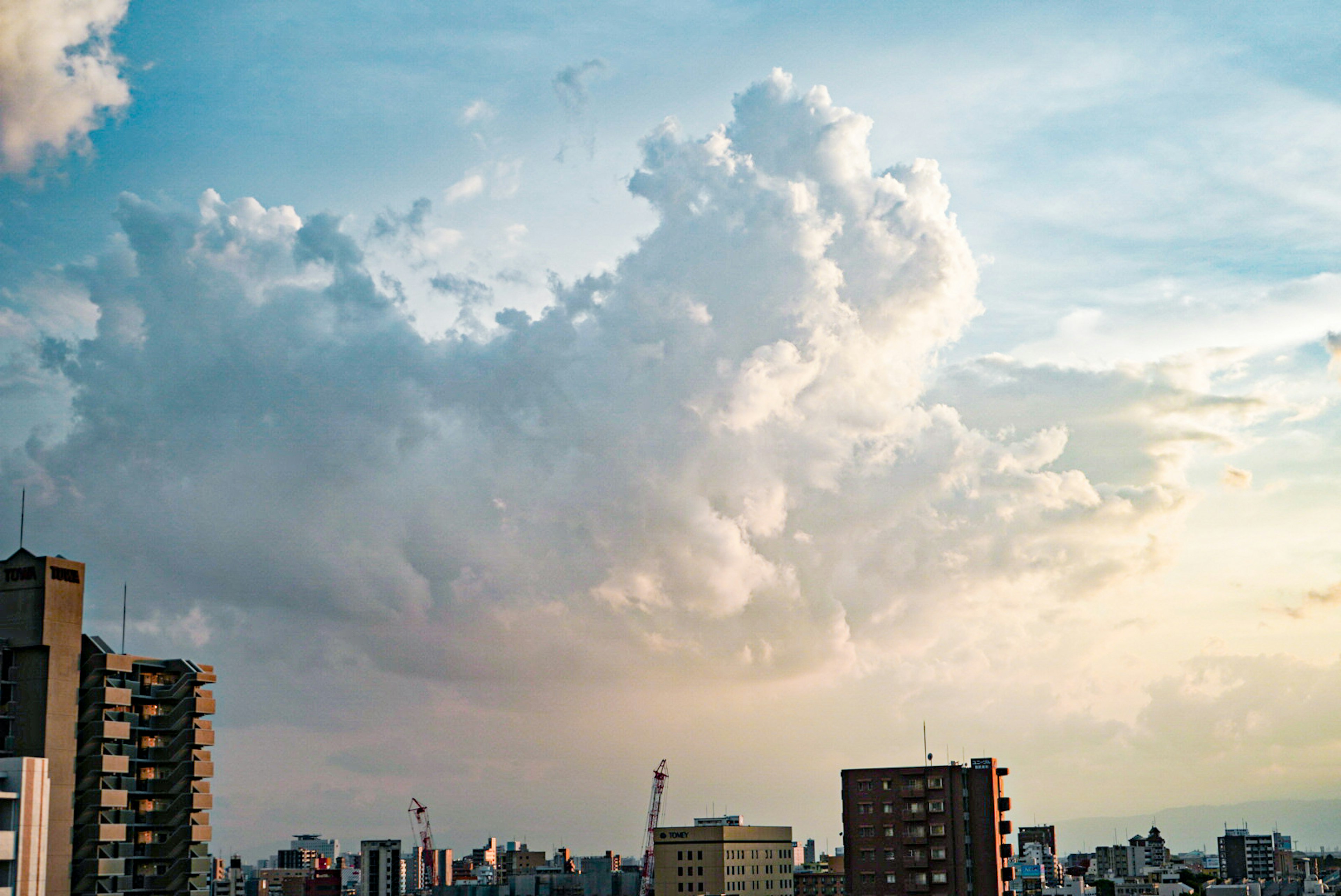 Cityscape at dusk with dramatic clouds