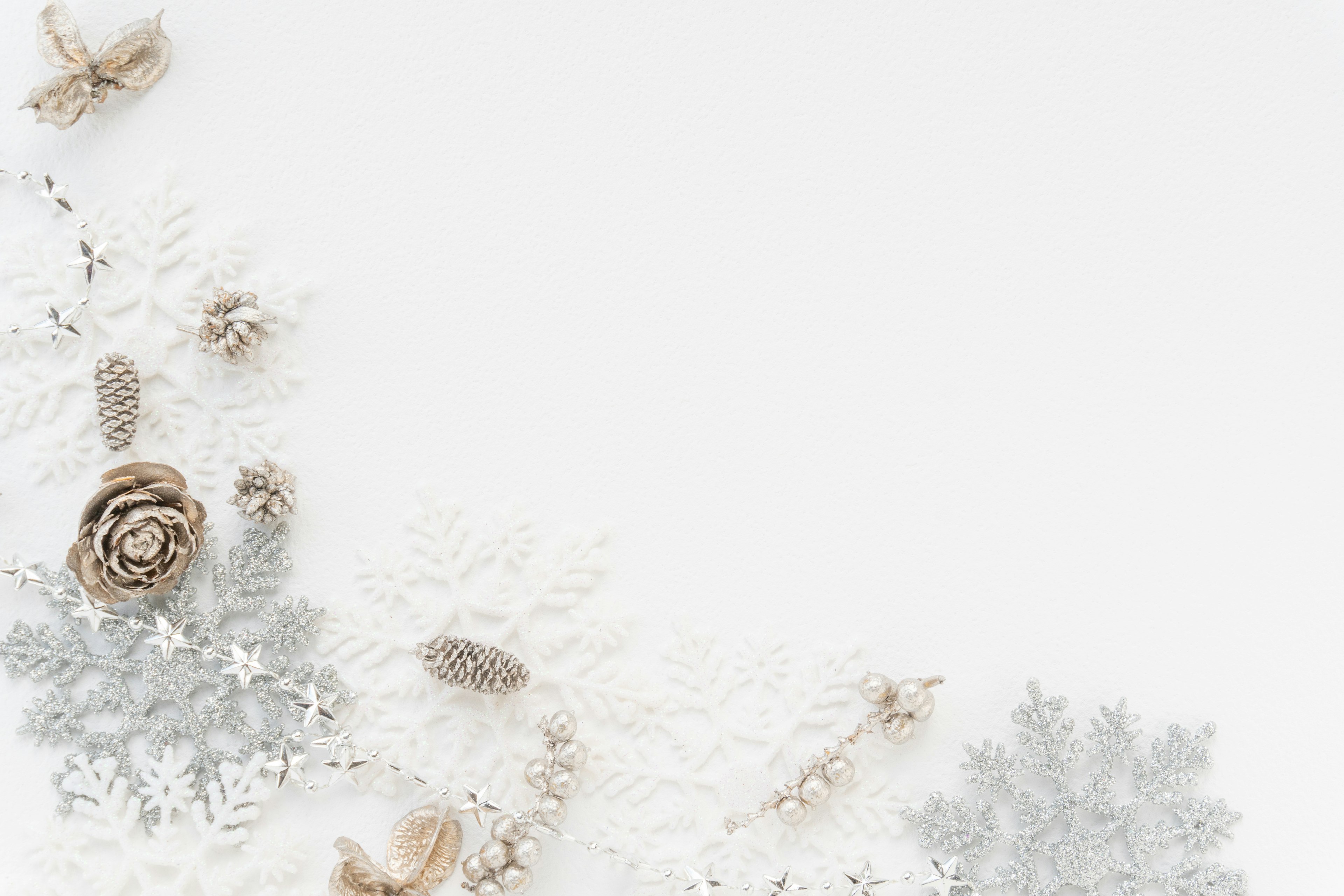 Winter arrangement featuring snowflakes and pine cones on a white background