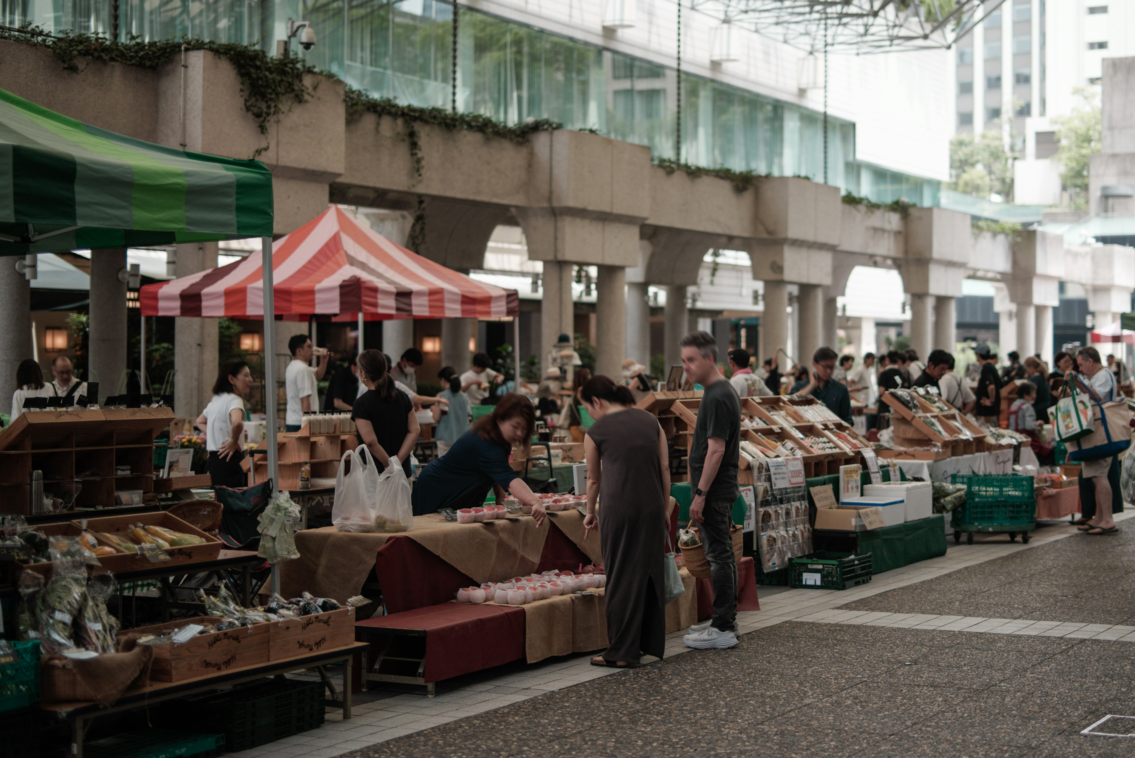 A bustling market scene with people browsing various stalls