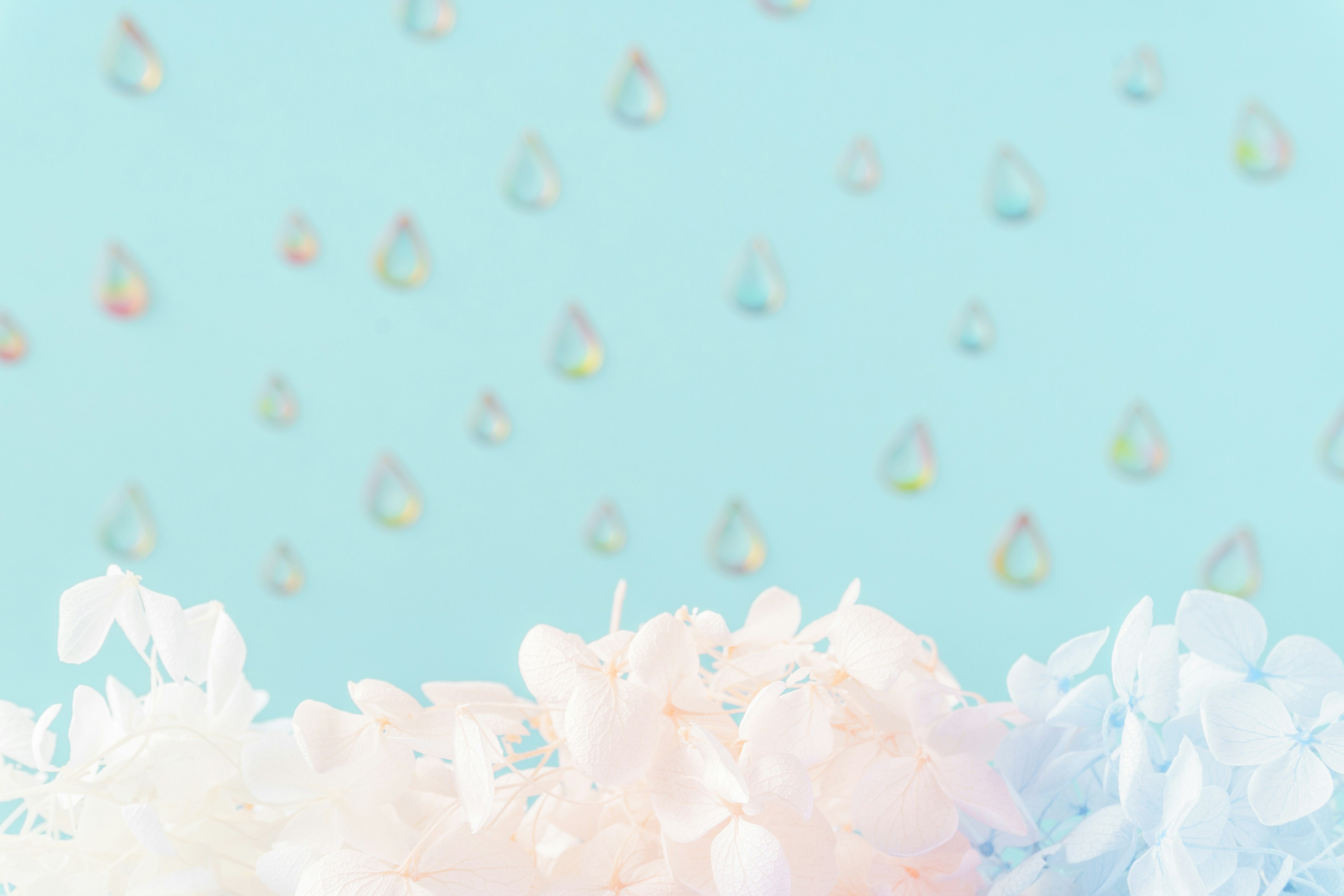 Image featuring delicate pastel flowers against a light blue background with shimmering droplets