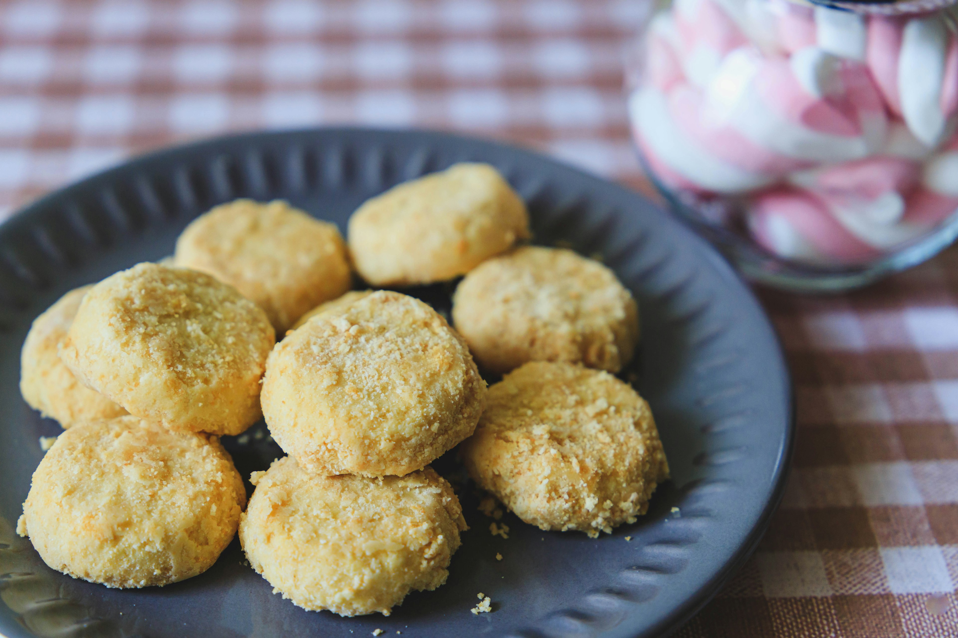 Freshly baked crunchy cookies on a black plate