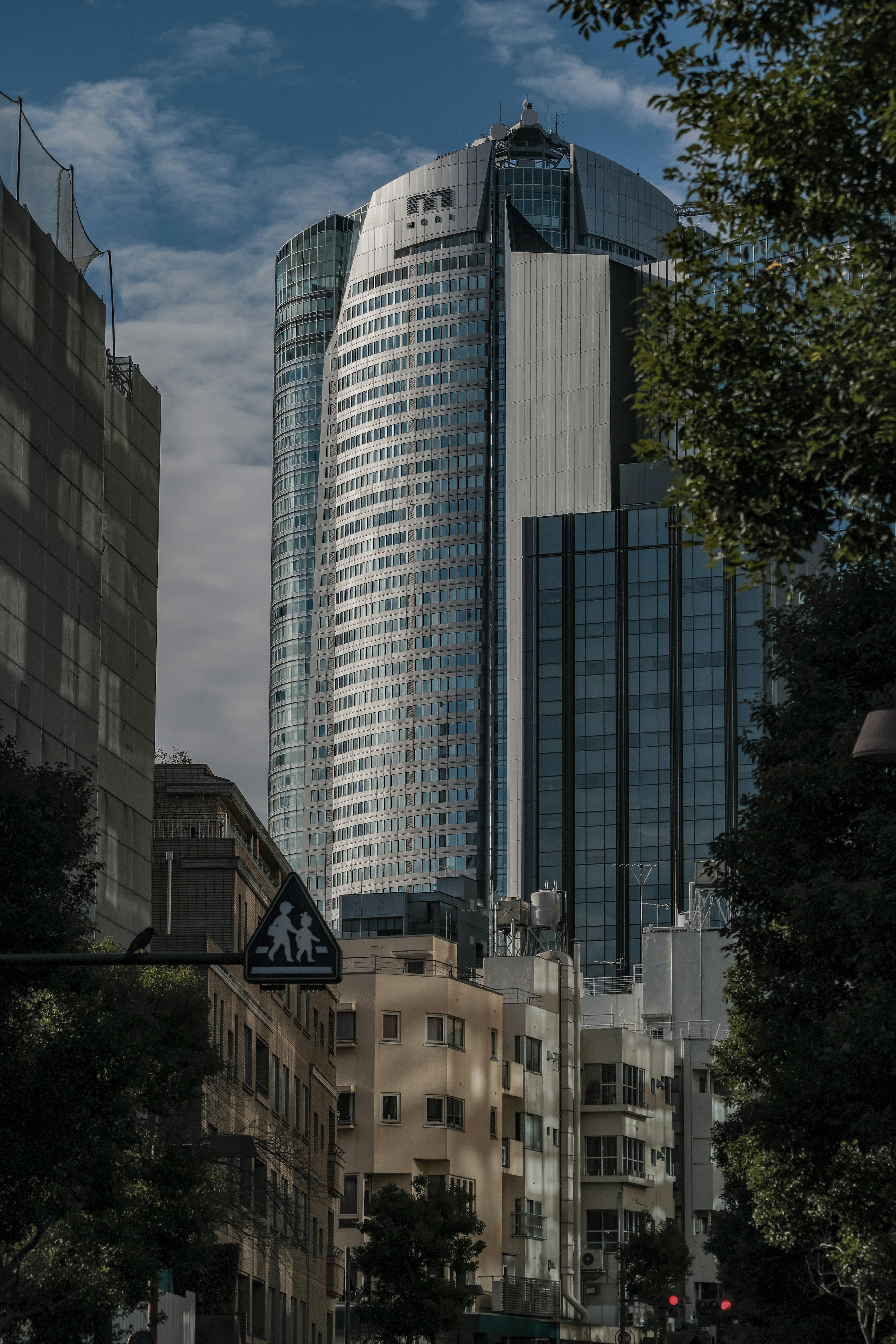 Close-up of a skyscraper with a cloudy sky