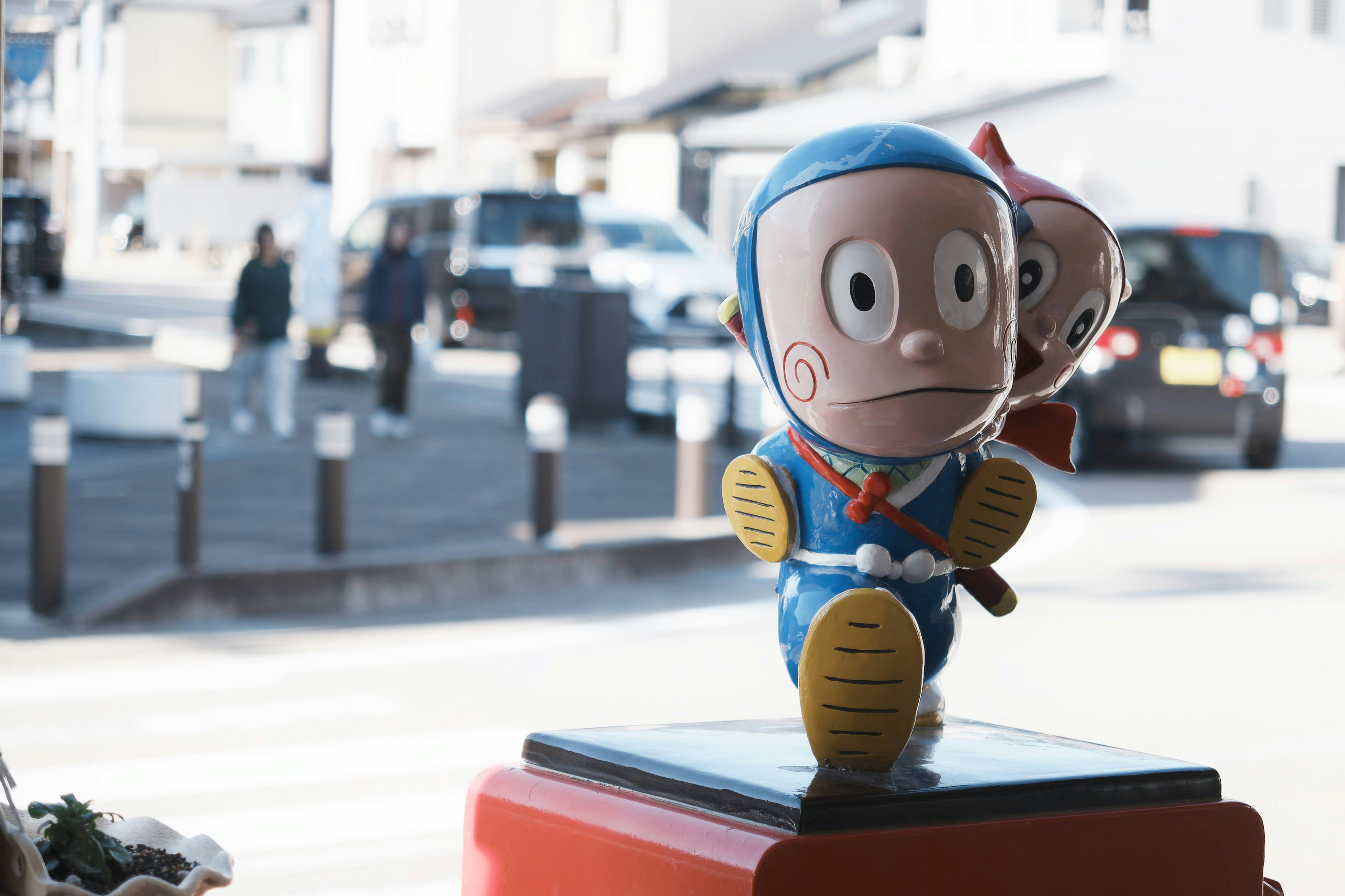 A blue ninja character standing with a street view in the background