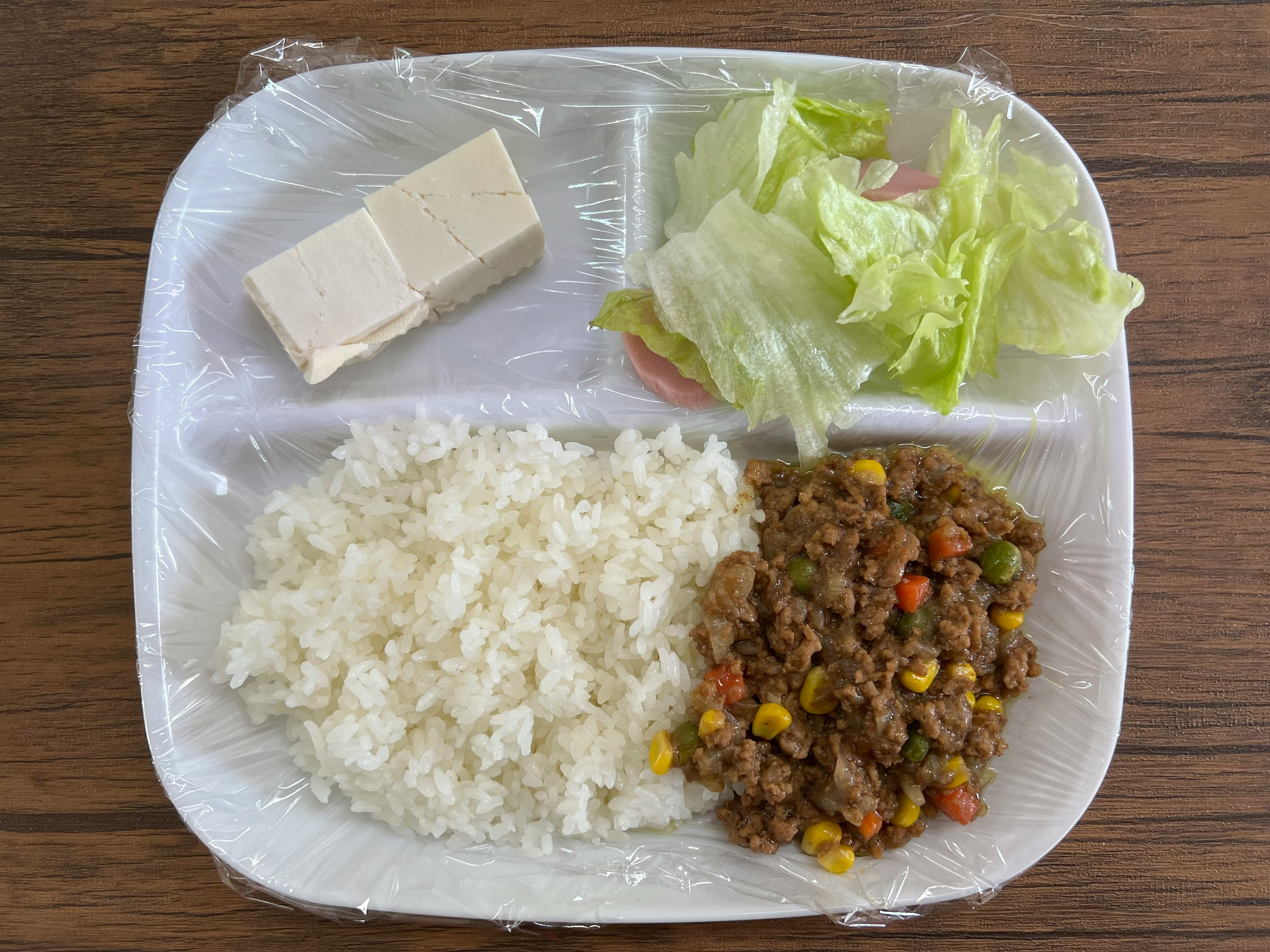 Plate with white rice, vegetable salad, tofu, and minced meat dish