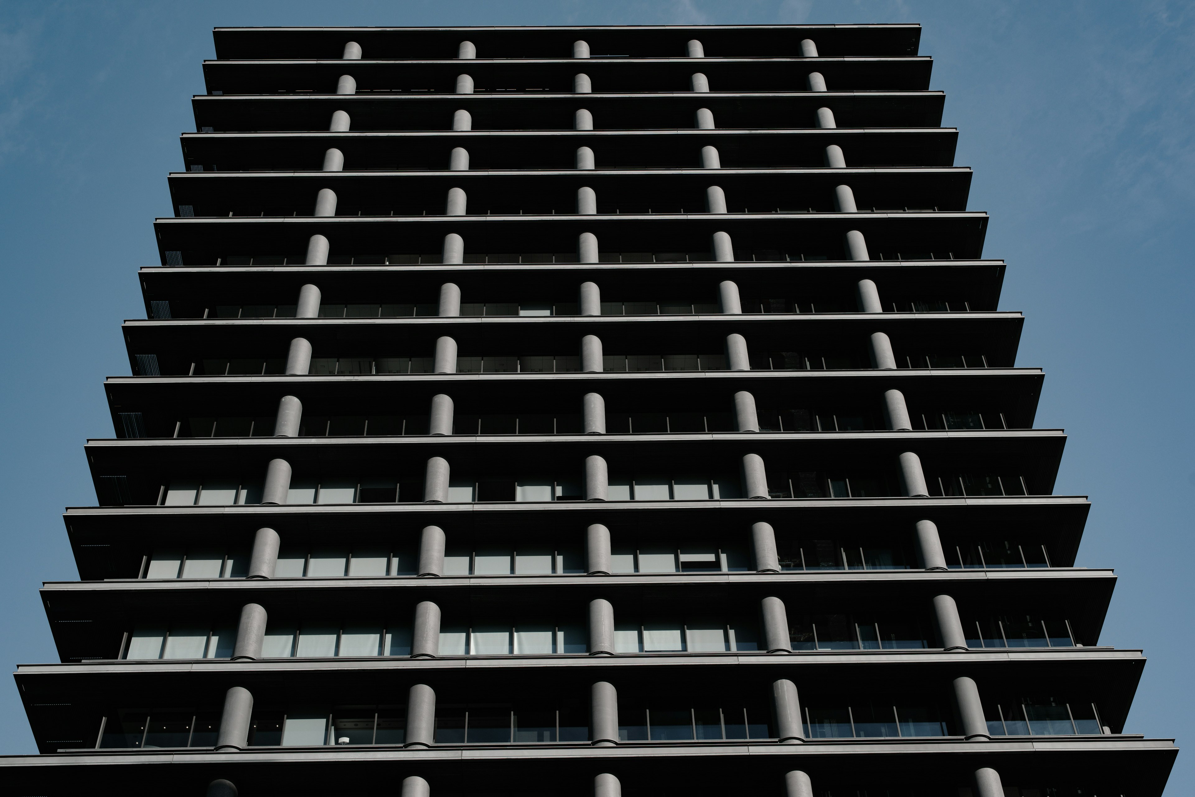 Facade of a high-rise building featuring modern design with windows and balconies