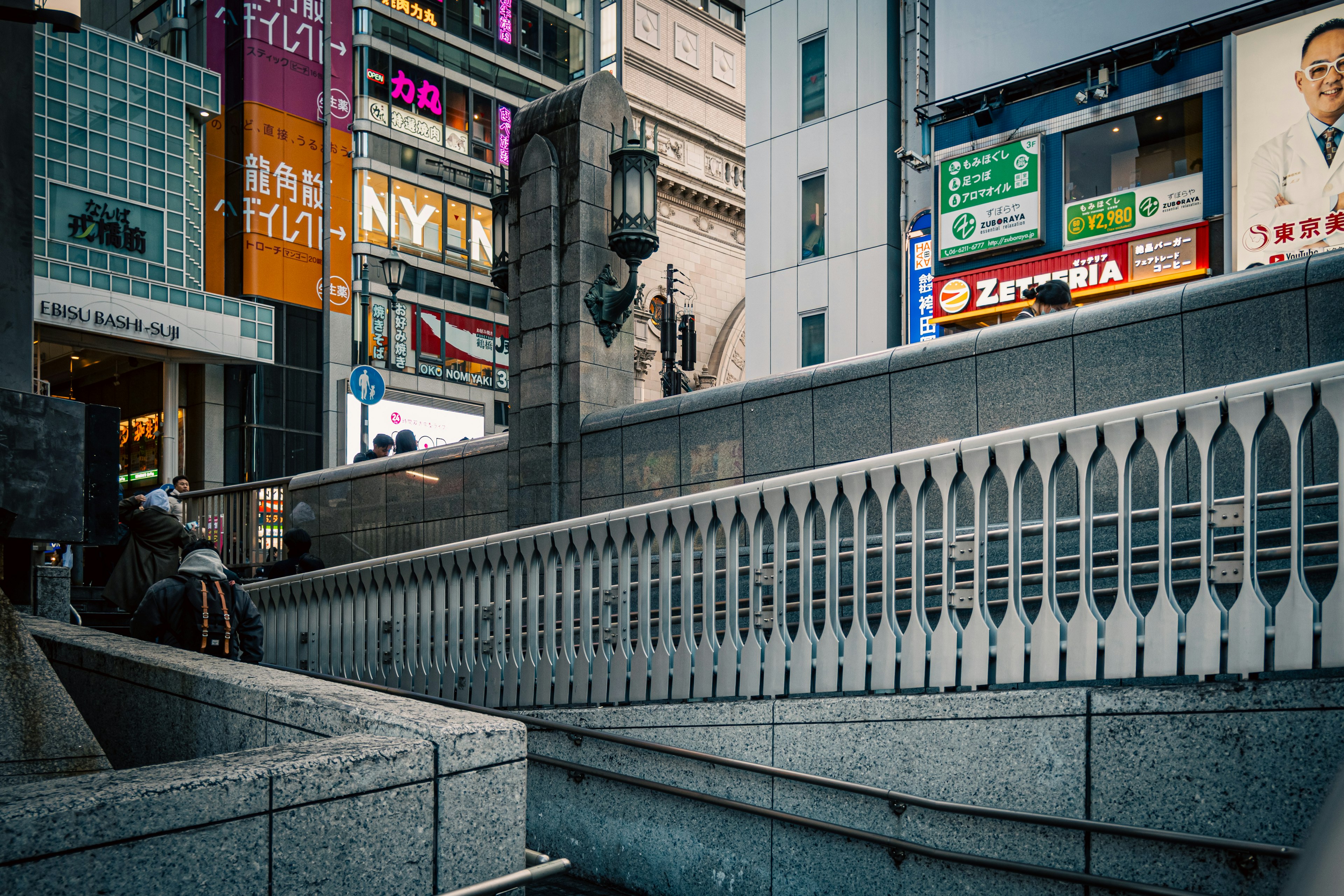 Urban scene featuring a bridge railing and surrounding buildings