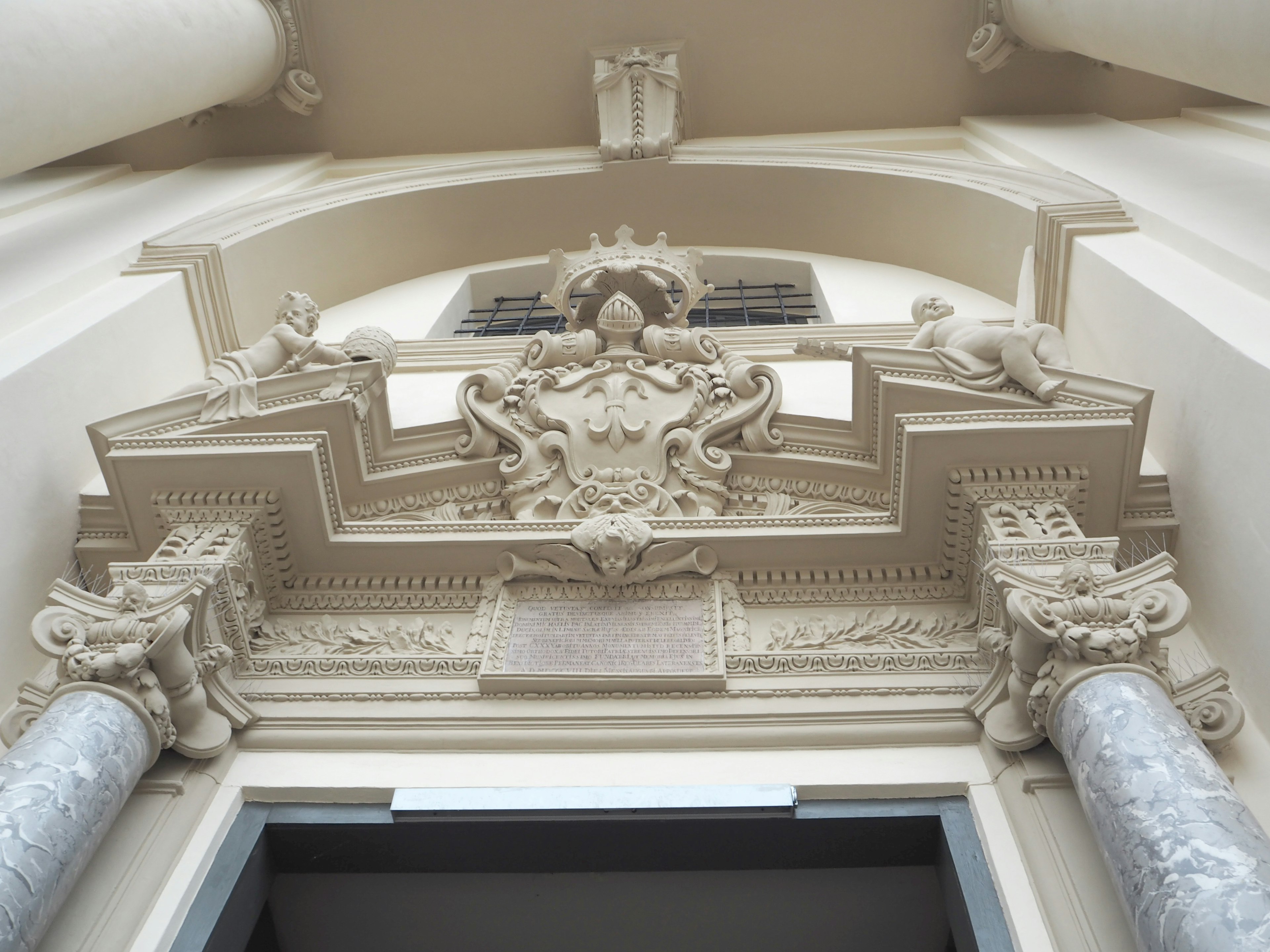 Detailed view of a decorative arch and columns at a building entrance