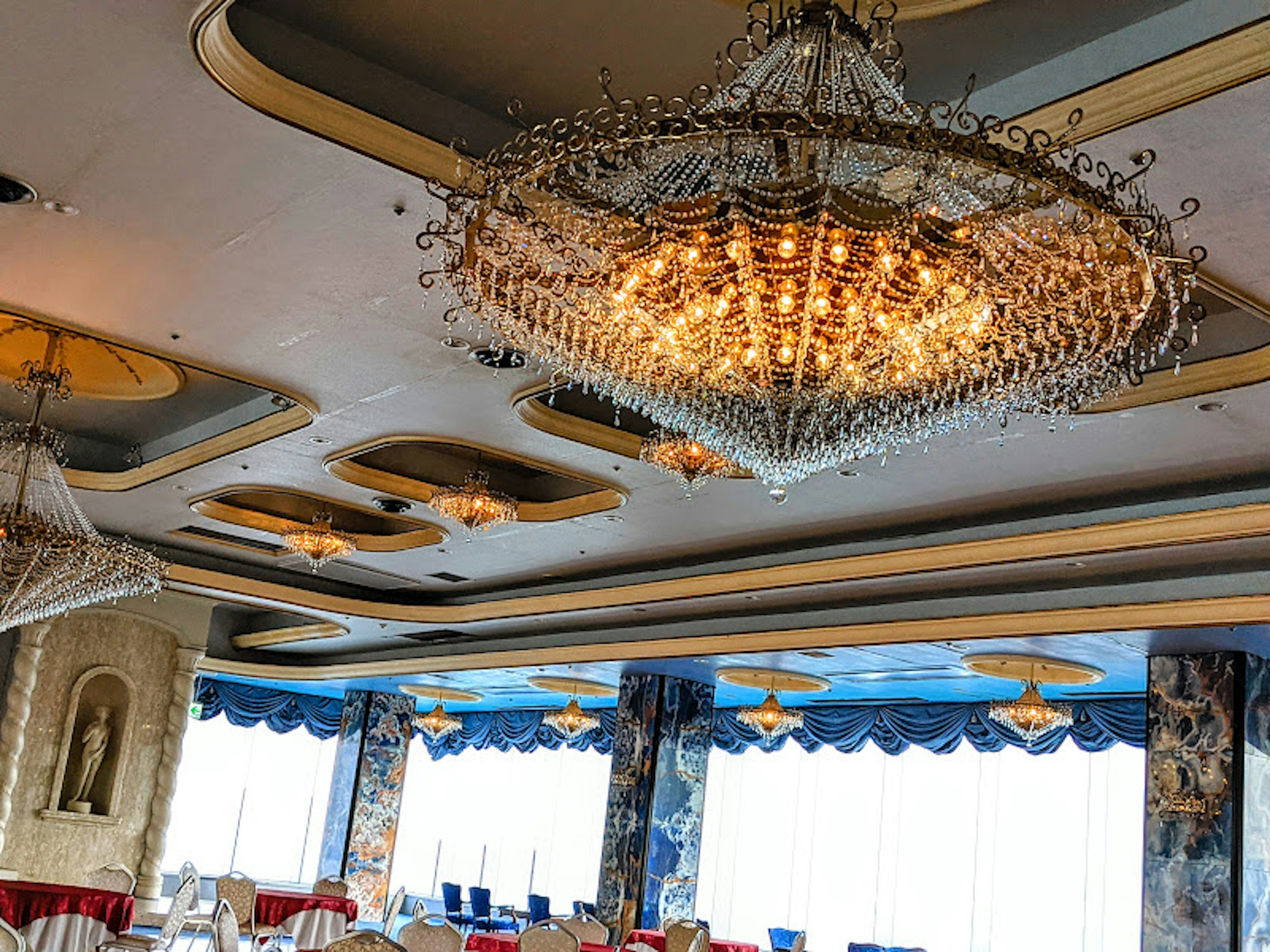 Interior of a bright dining room featuring an elegant chandelier