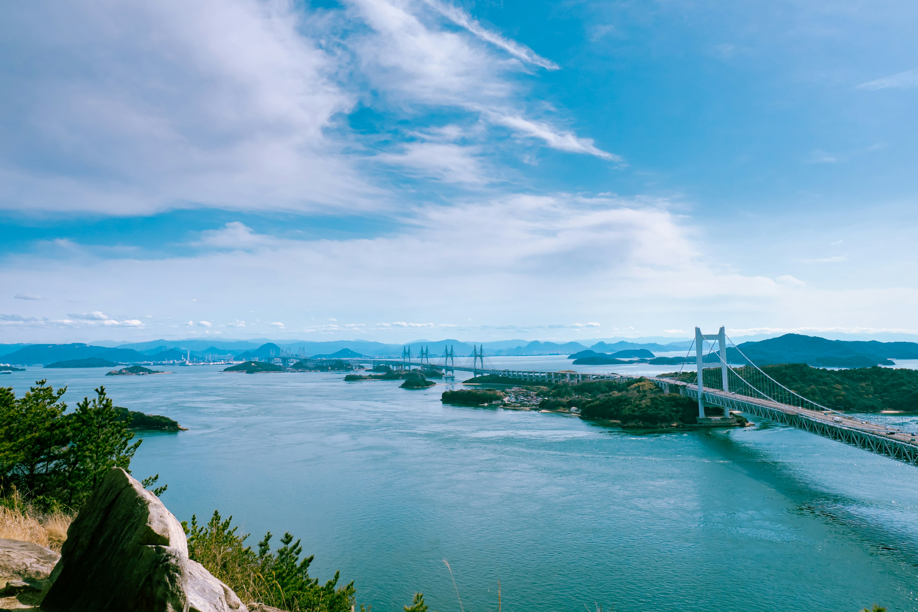 Scenic view of a blue sea with a bridge