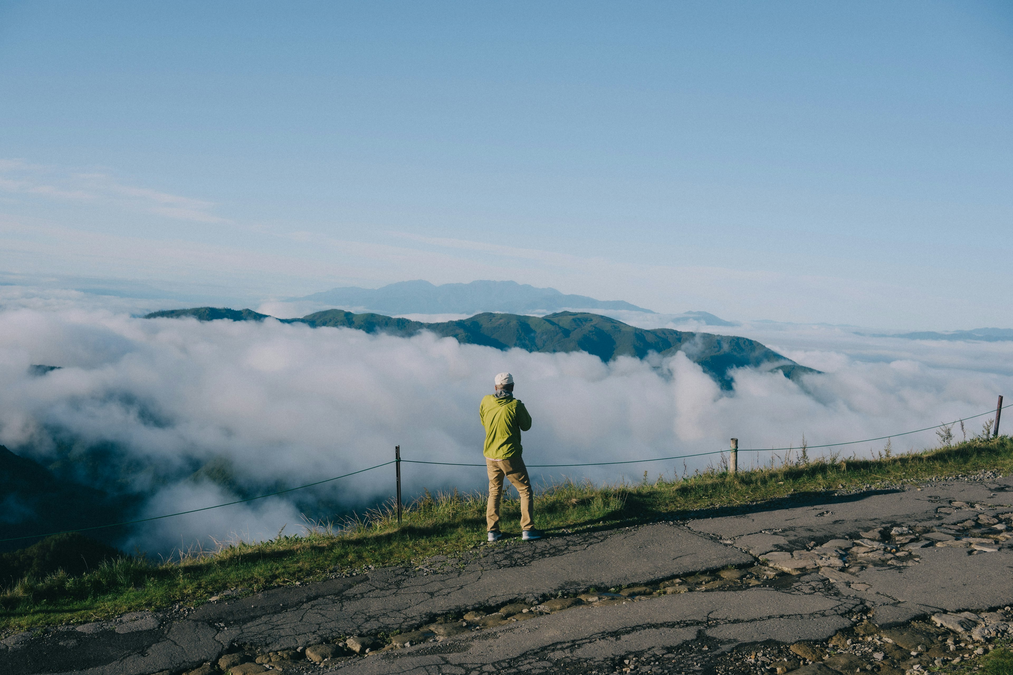 Photographer standing against a sea of clouds