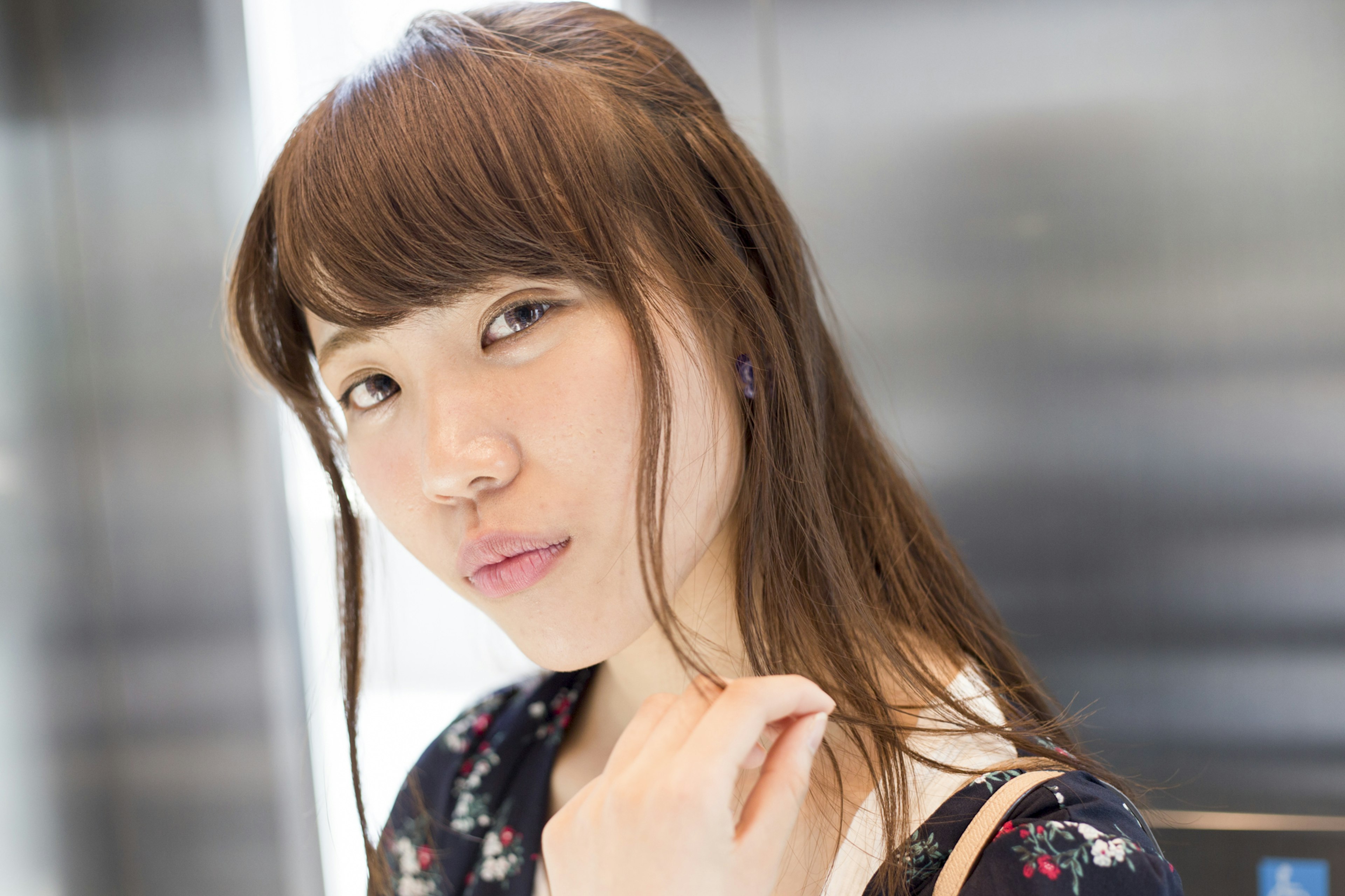 Portrait of a woman in an elevator Natural light illuminating her face with a subtle smile