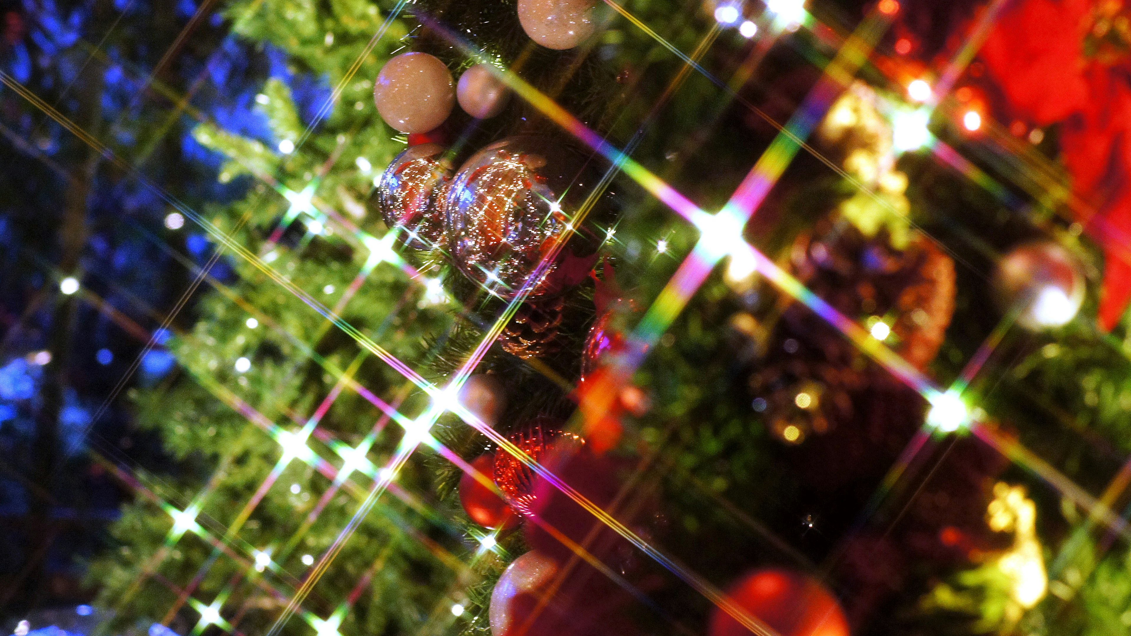 Close-up of a Christmas tree with colorful ornaments and sparkling lights