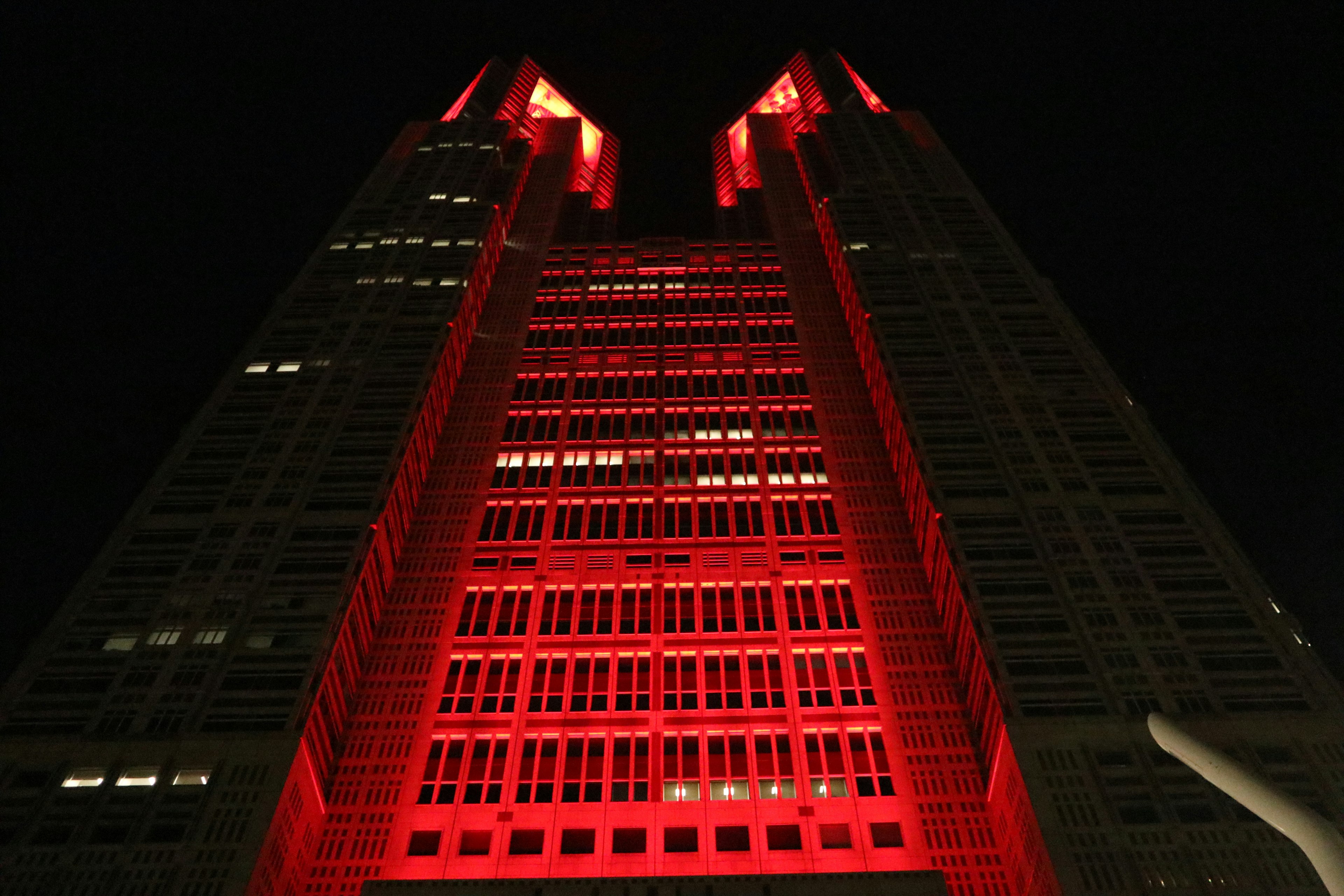 Skyscraper illuminated in red at night