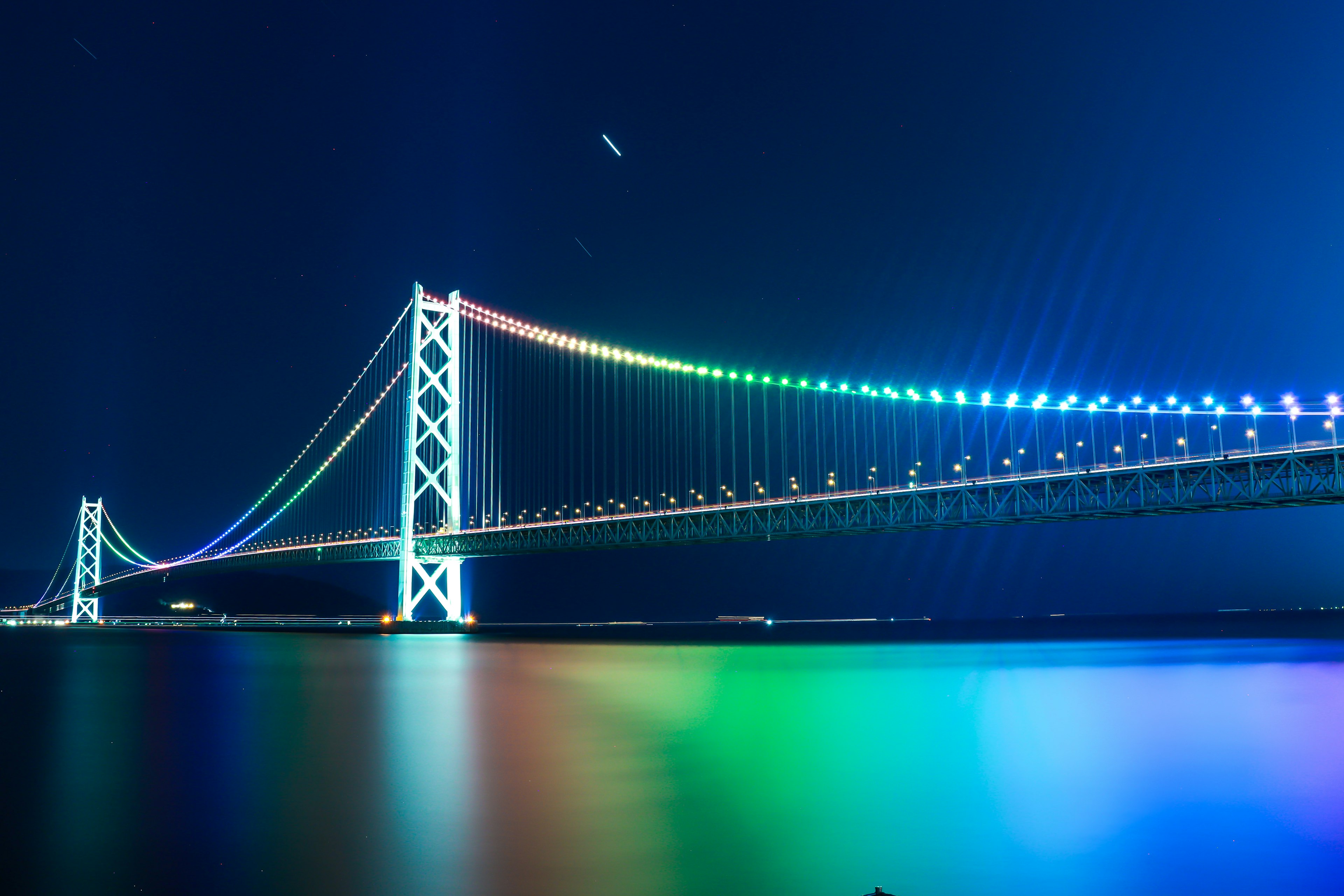 Un magnifique pont en arc illuminé de lumières colorées dans un ciel nocturne