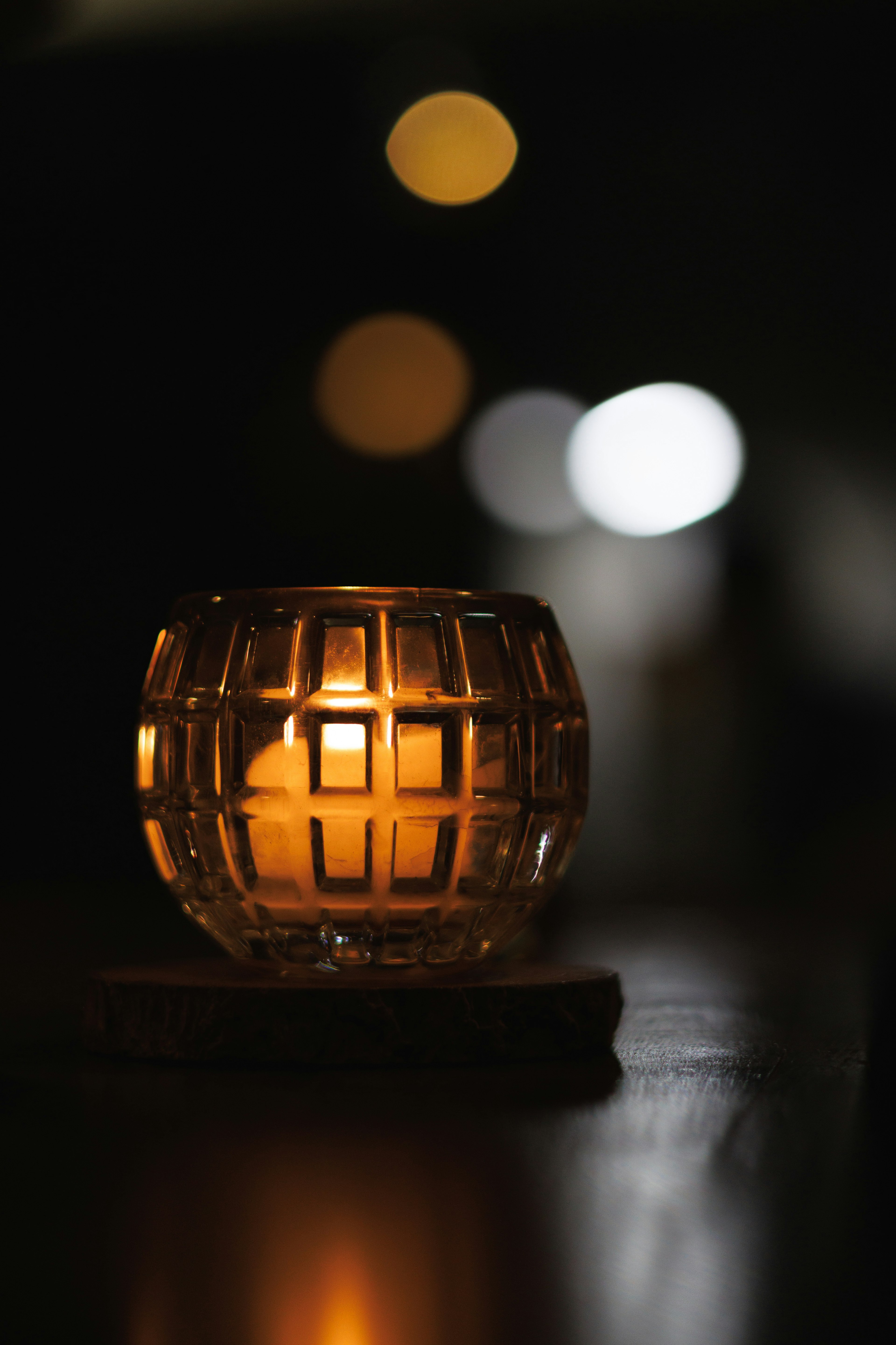 Close-up of a bright candle holder against a dark background