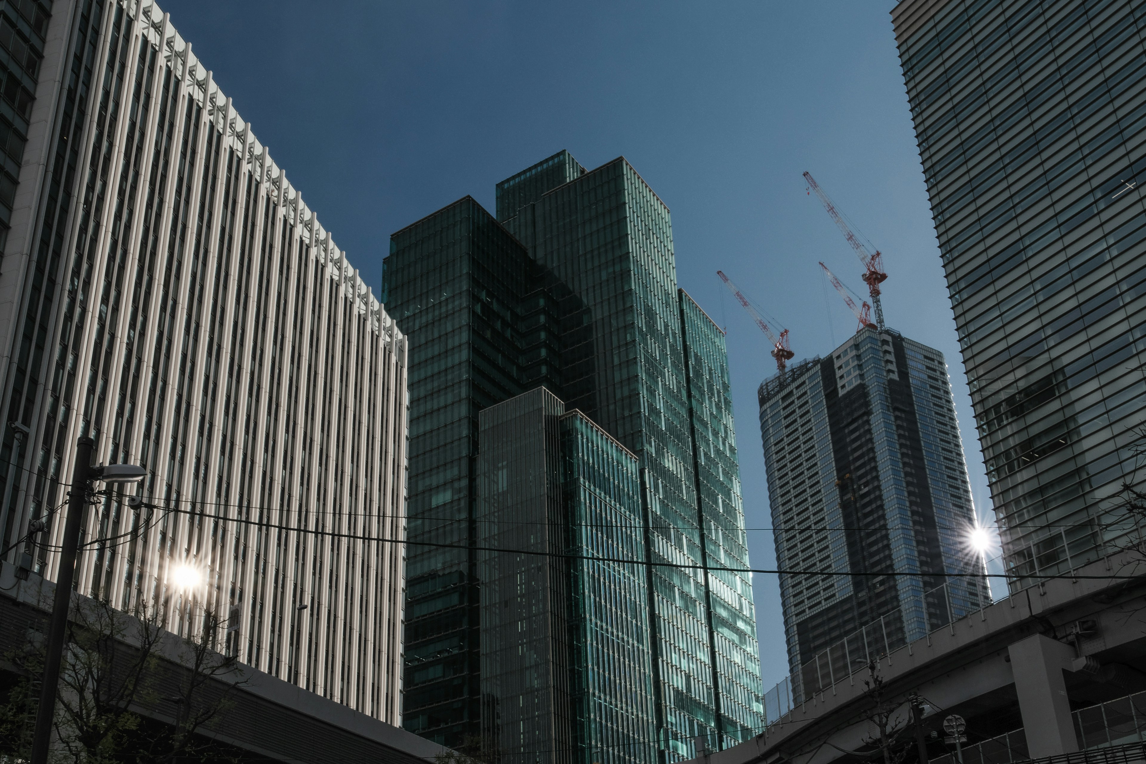 Urban landscape with towering skyscrapers under a blue sky