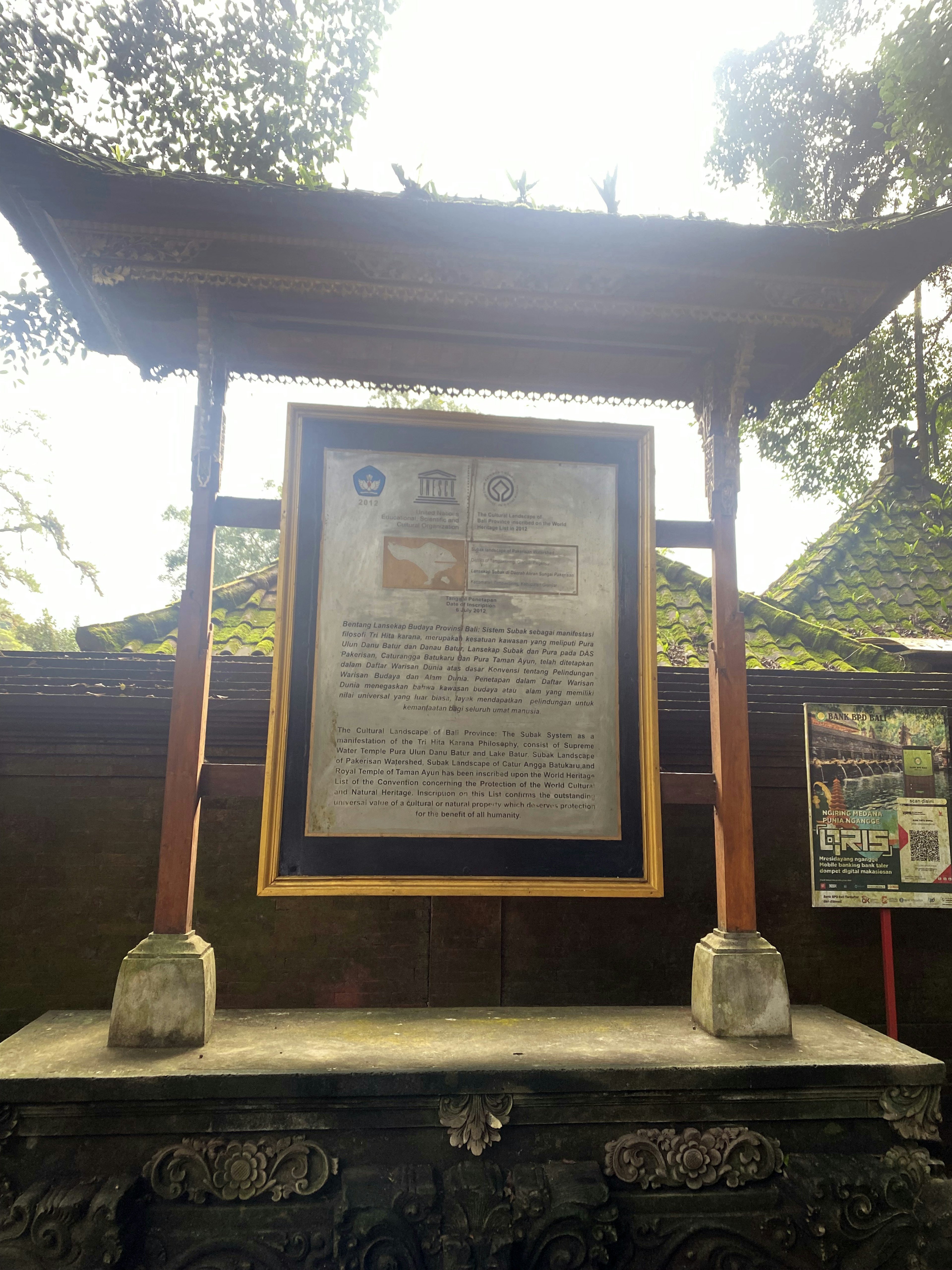 Image of an informational plaque under a wooden roof