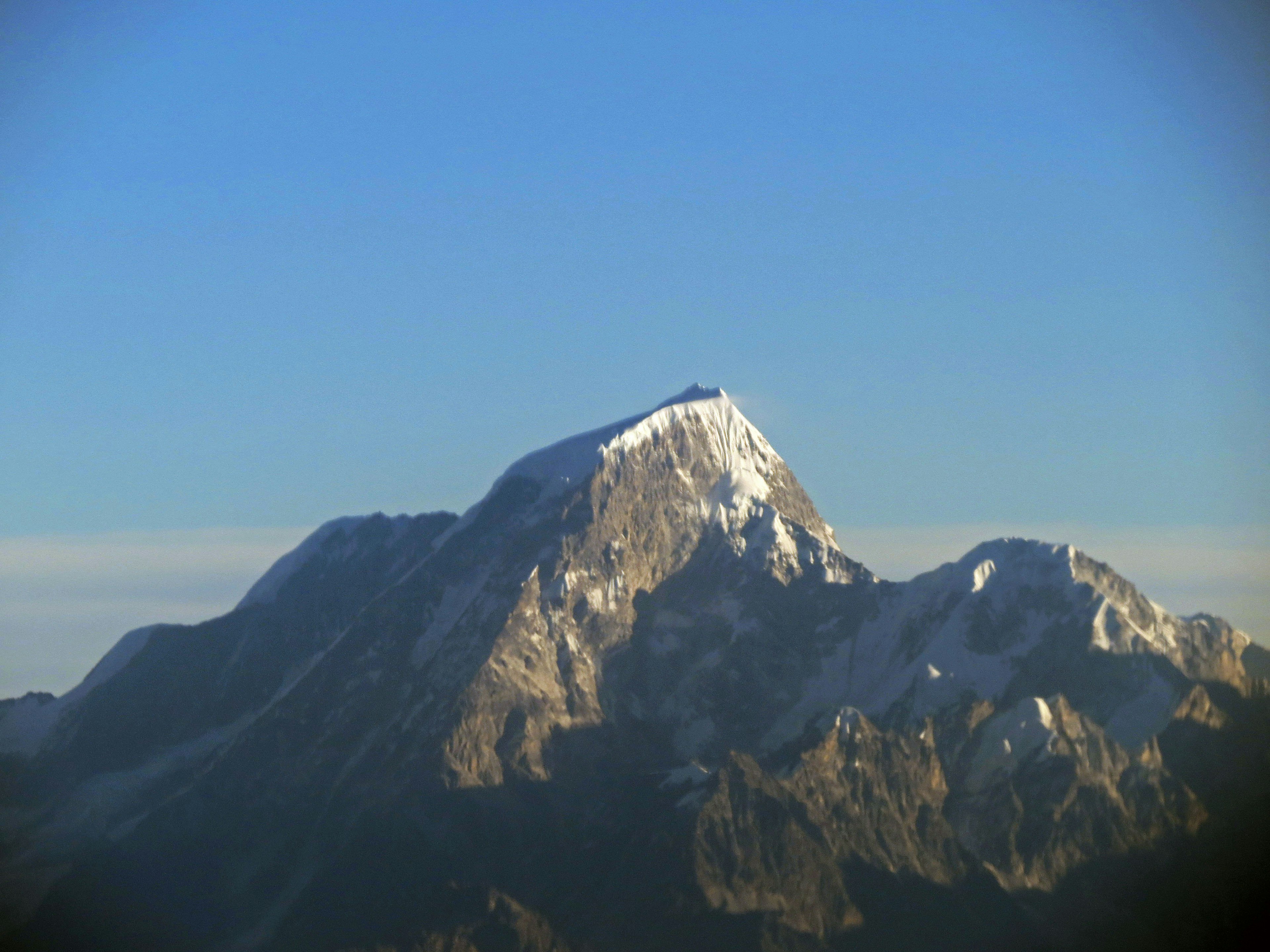 Snow-capped mountain peak against a blue sky