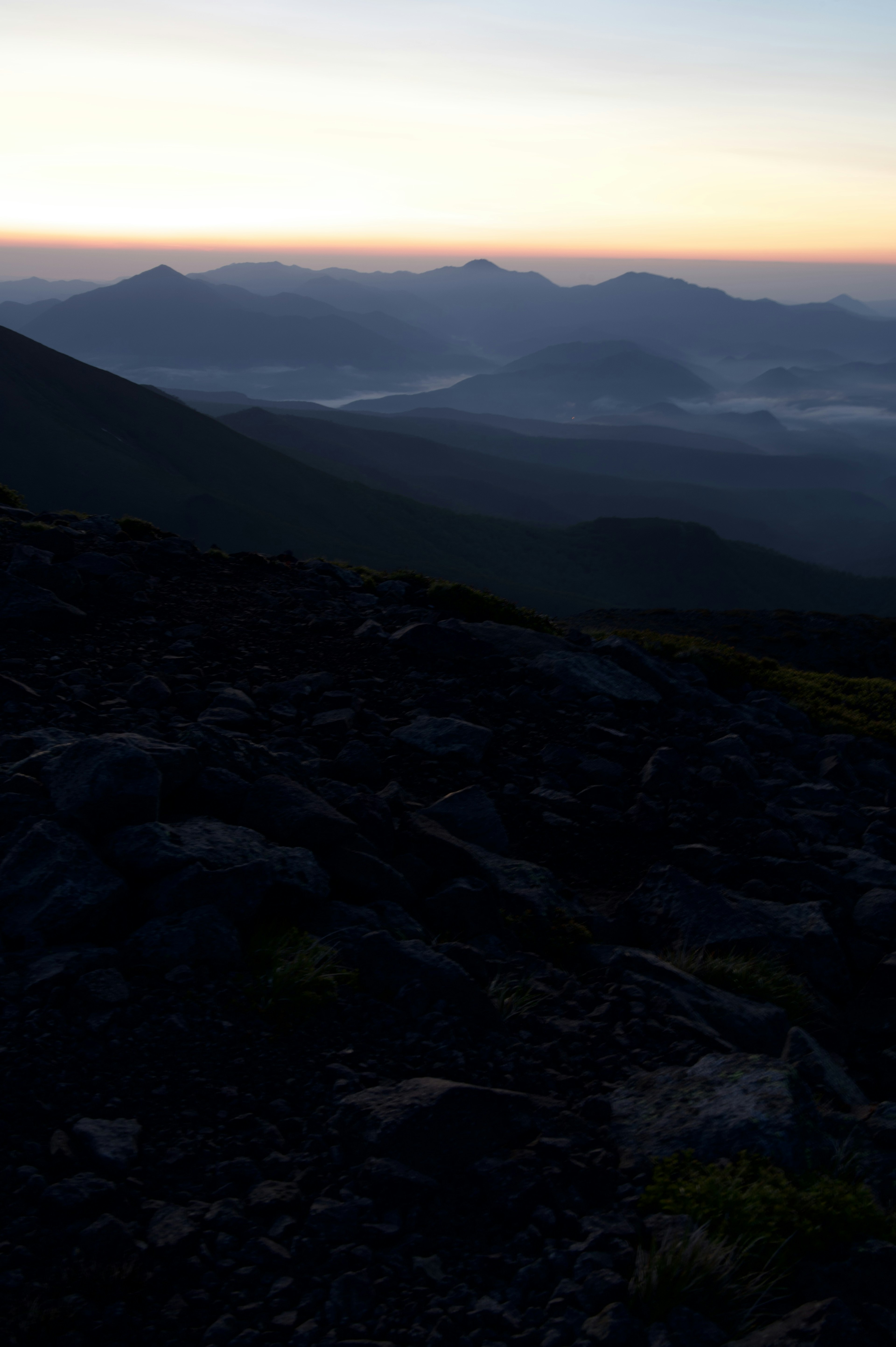 Silhouetted mountains against a dawn sky