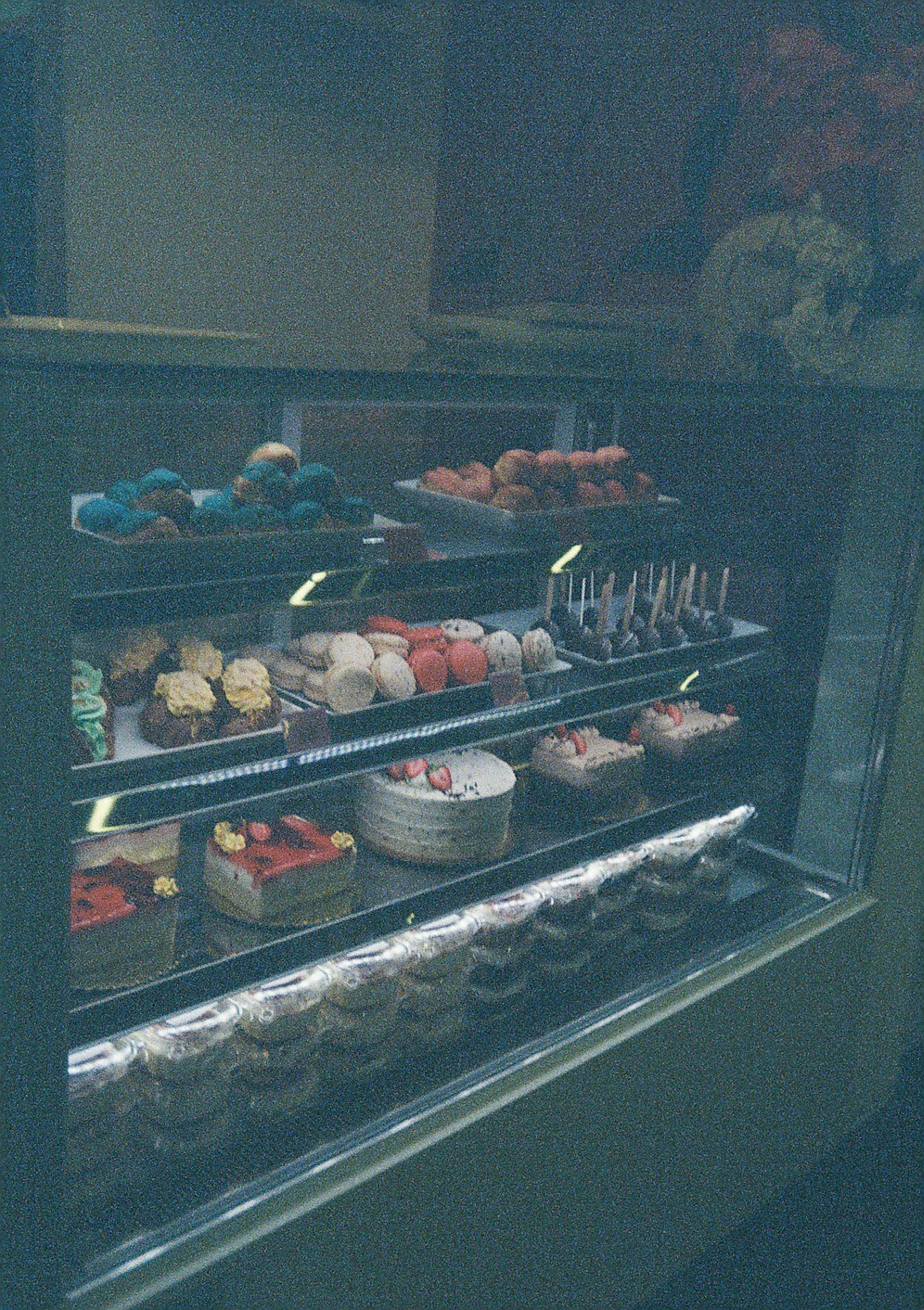 Colorful desserts and sweets displayed in a showcase