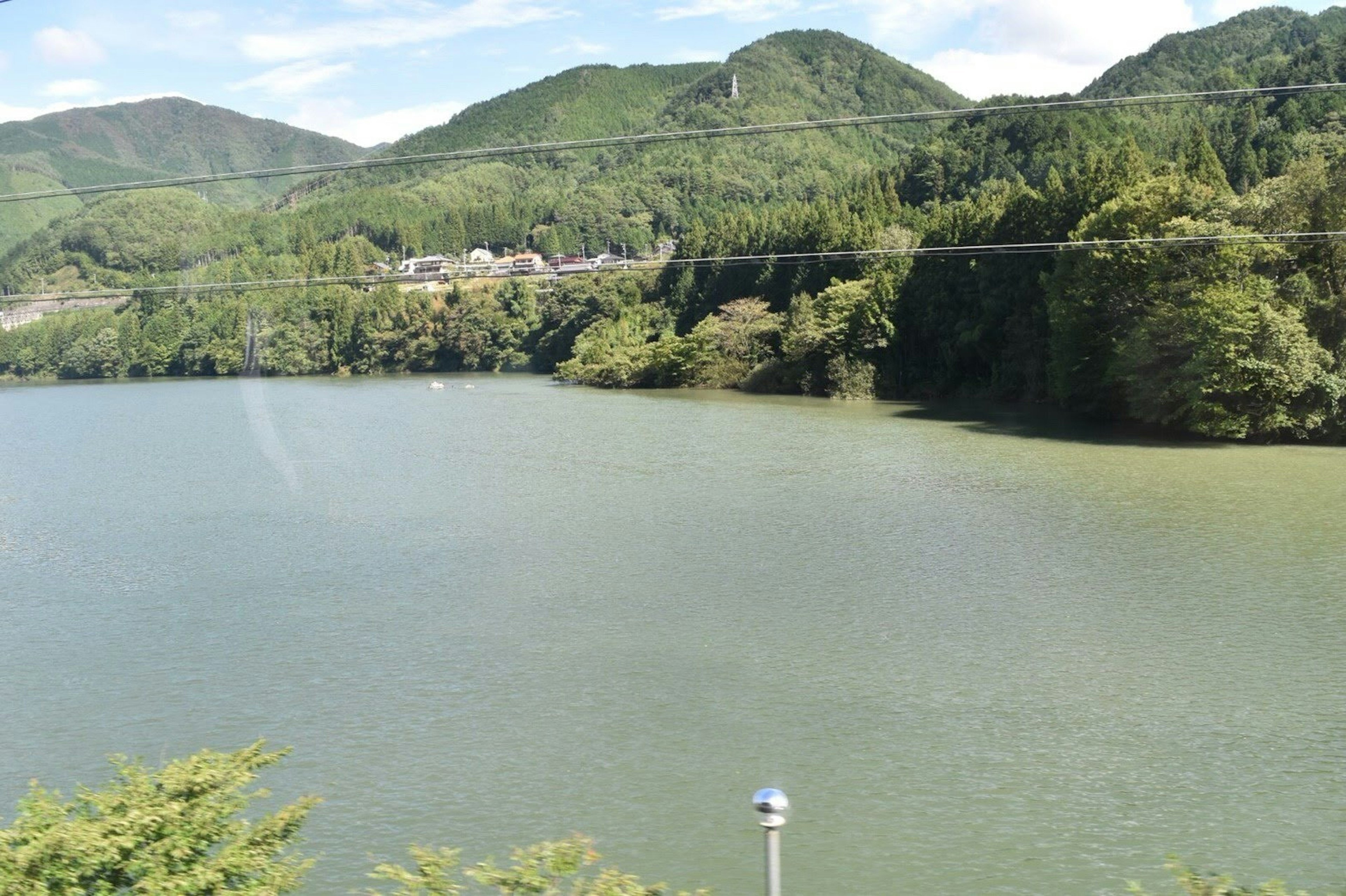 Scenic view of a tranquil lake surrounded by green mountains