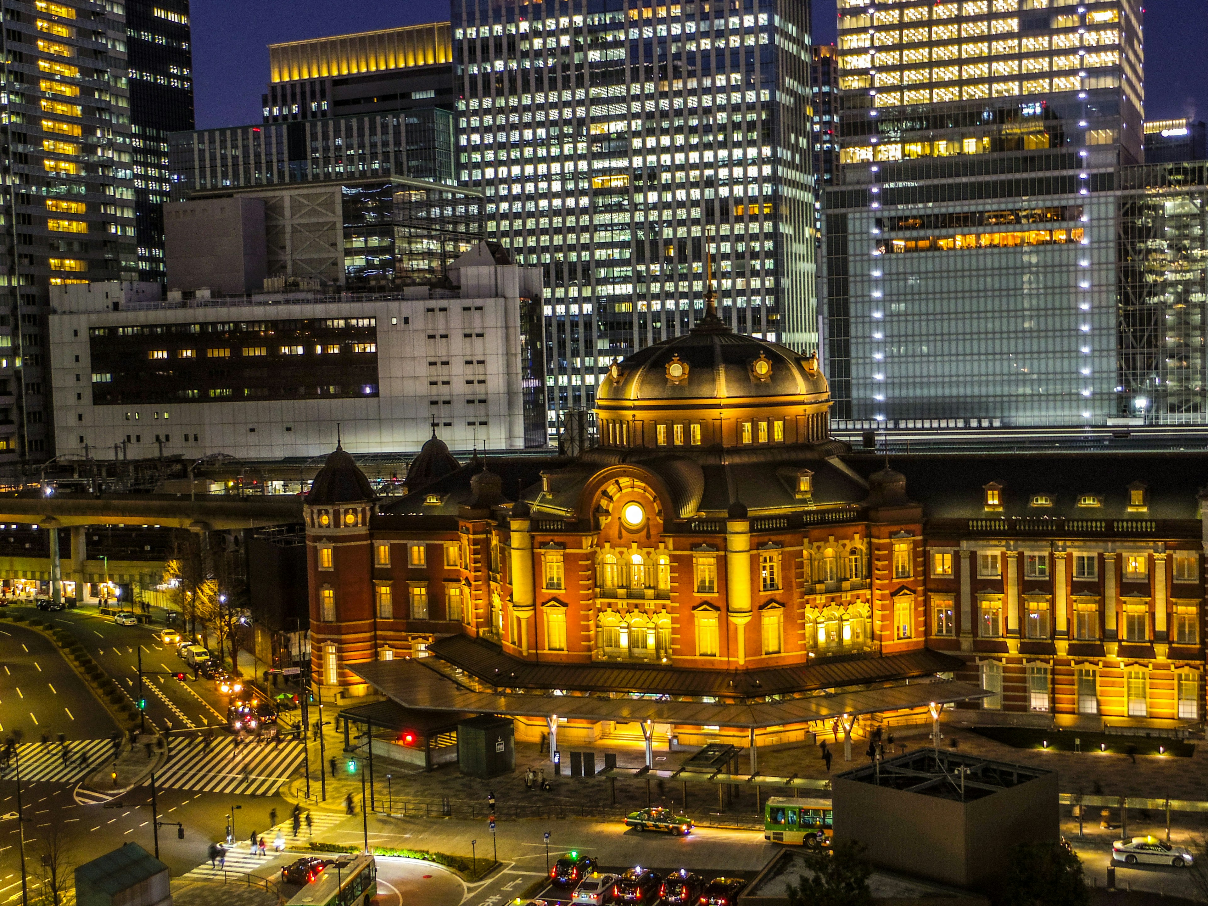 Tokyo Station at night featuring vibrant lighting and modern skyscrapers