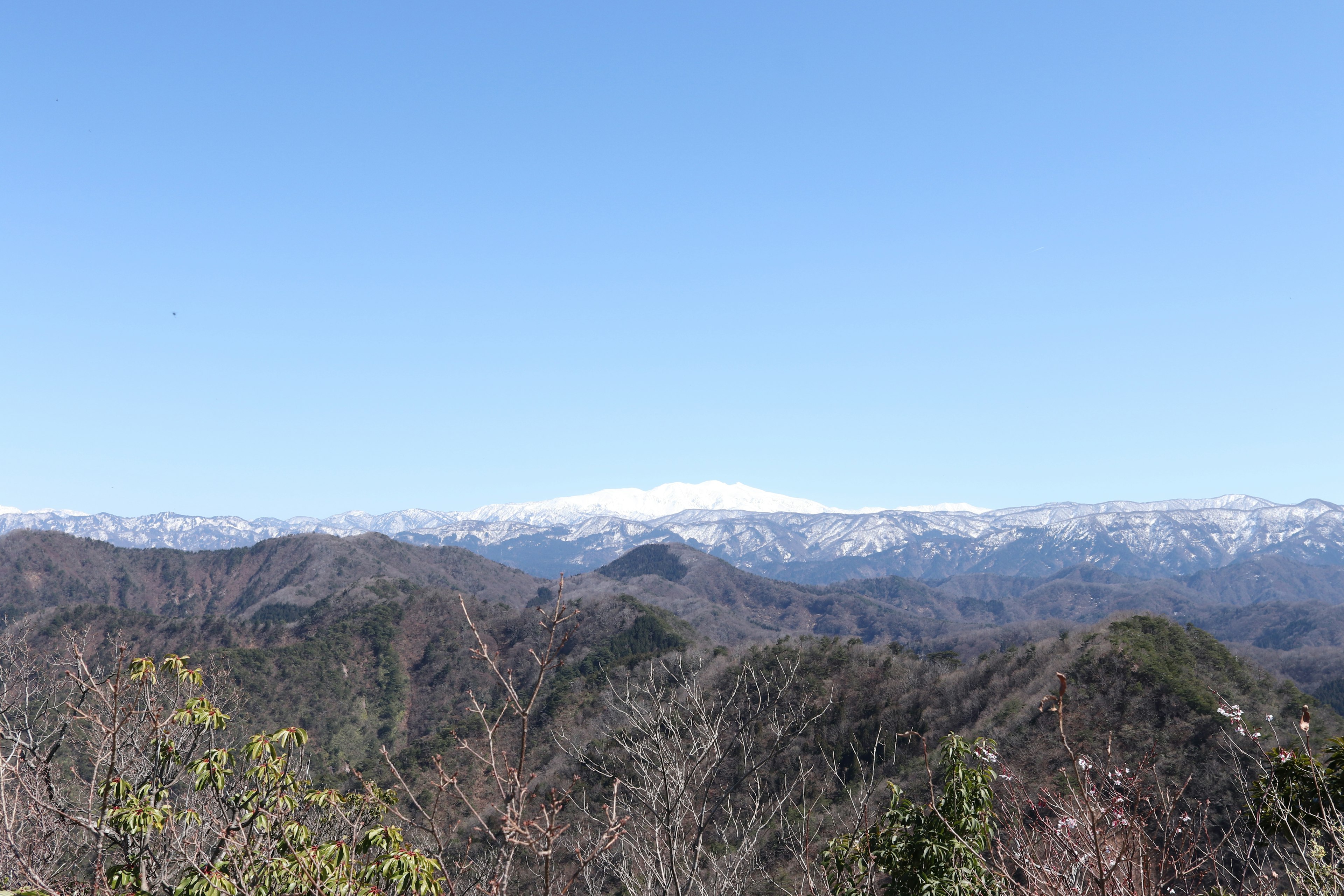 Snow-capped mountains under a clear blue sky