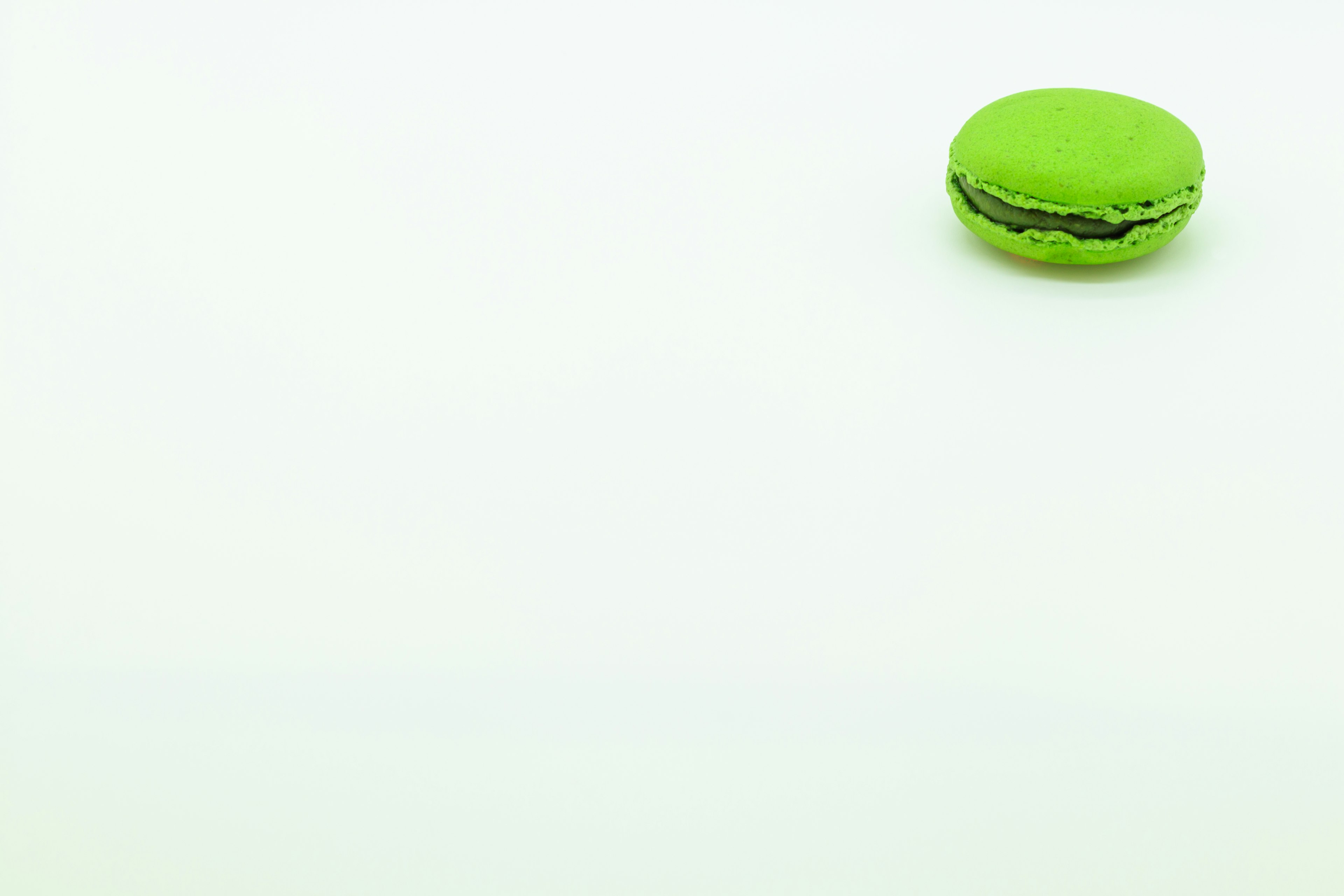 Green macaron placed on a white background