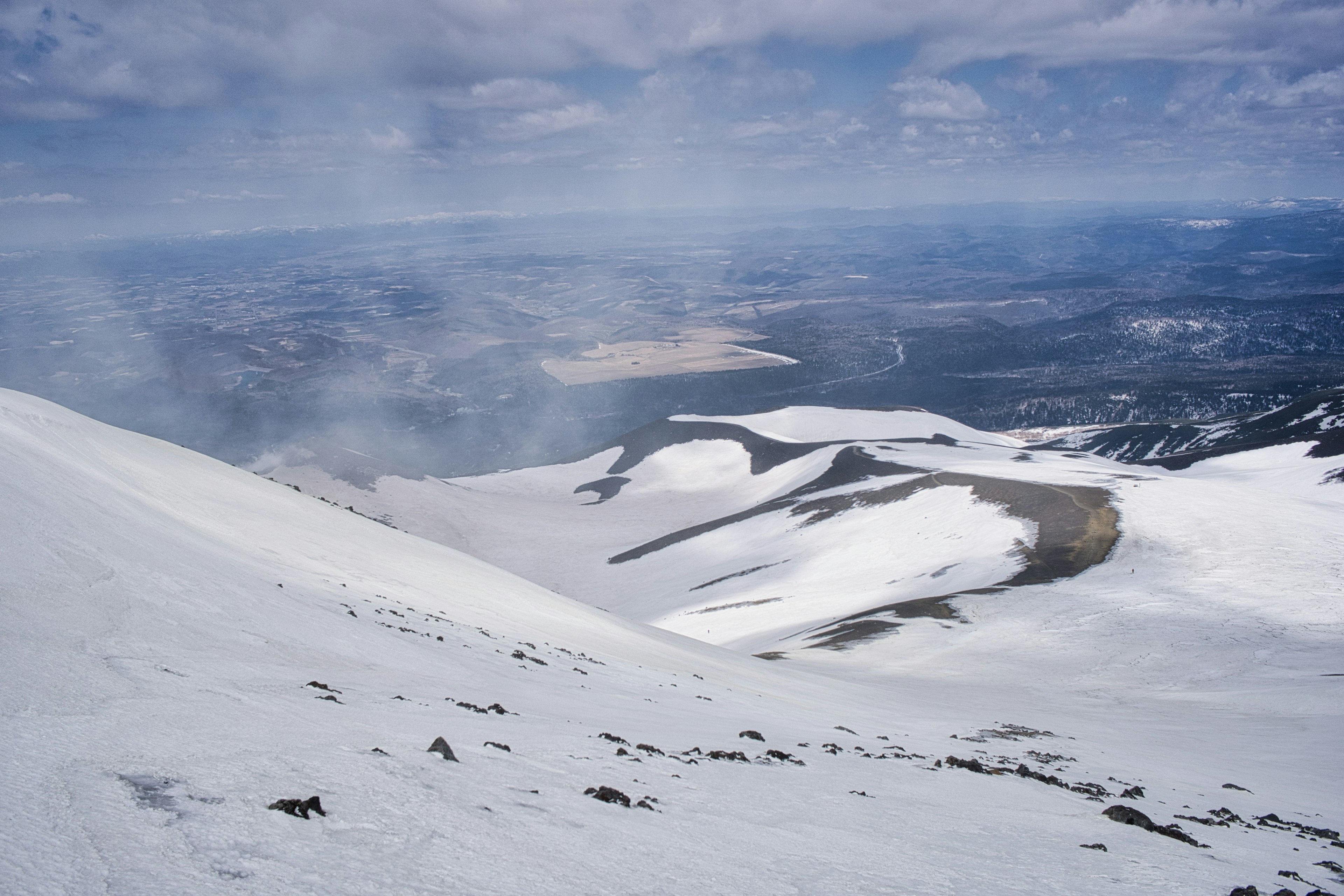 Ladera de montaña cubierta de nieve con vista al valle abajo