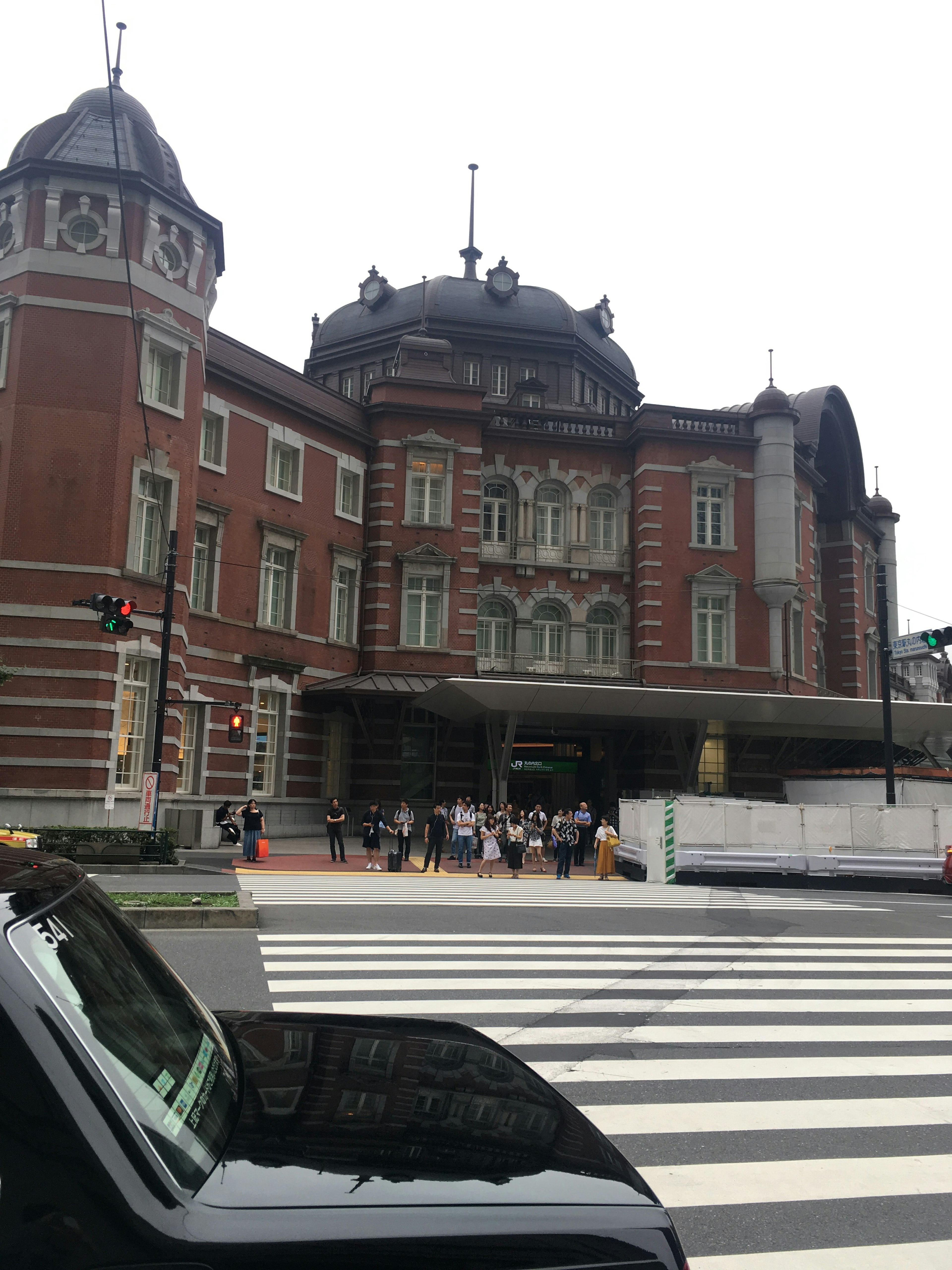 Historic Tokyo Station building with crosswalk in view