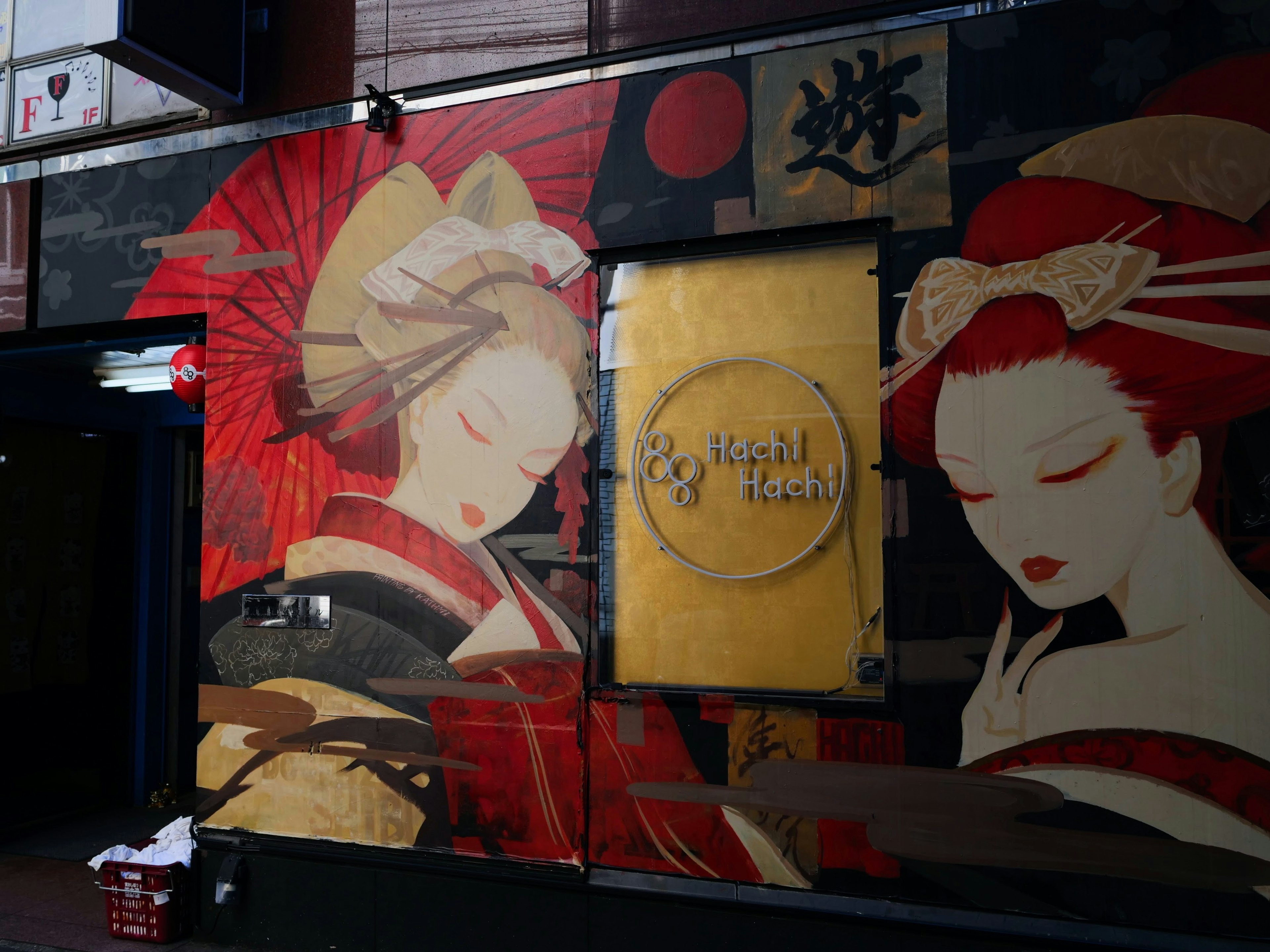 A beautiful mural featuring two women in red kimonos