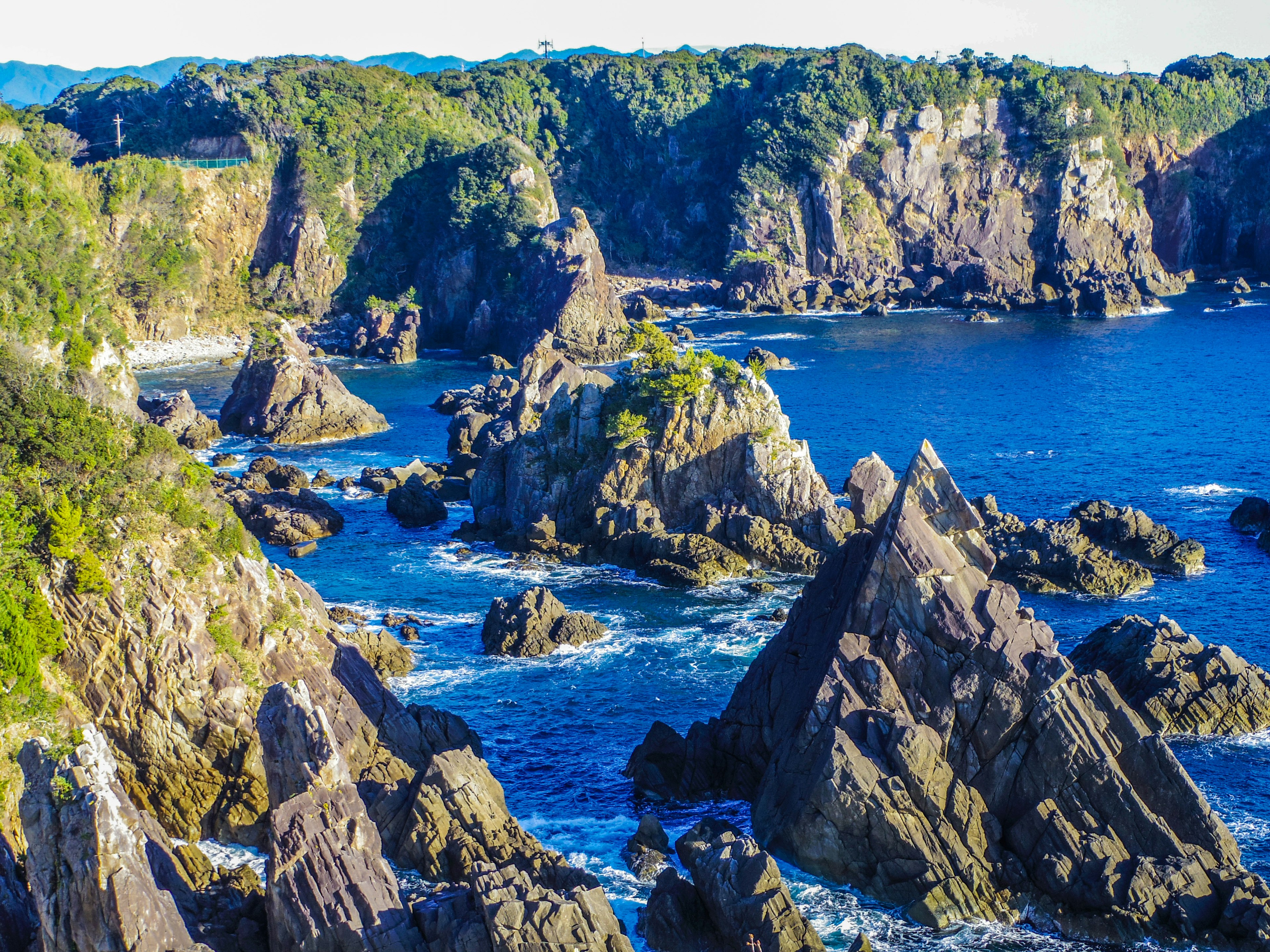 Scenic coastline with rocky formations and clear blue water