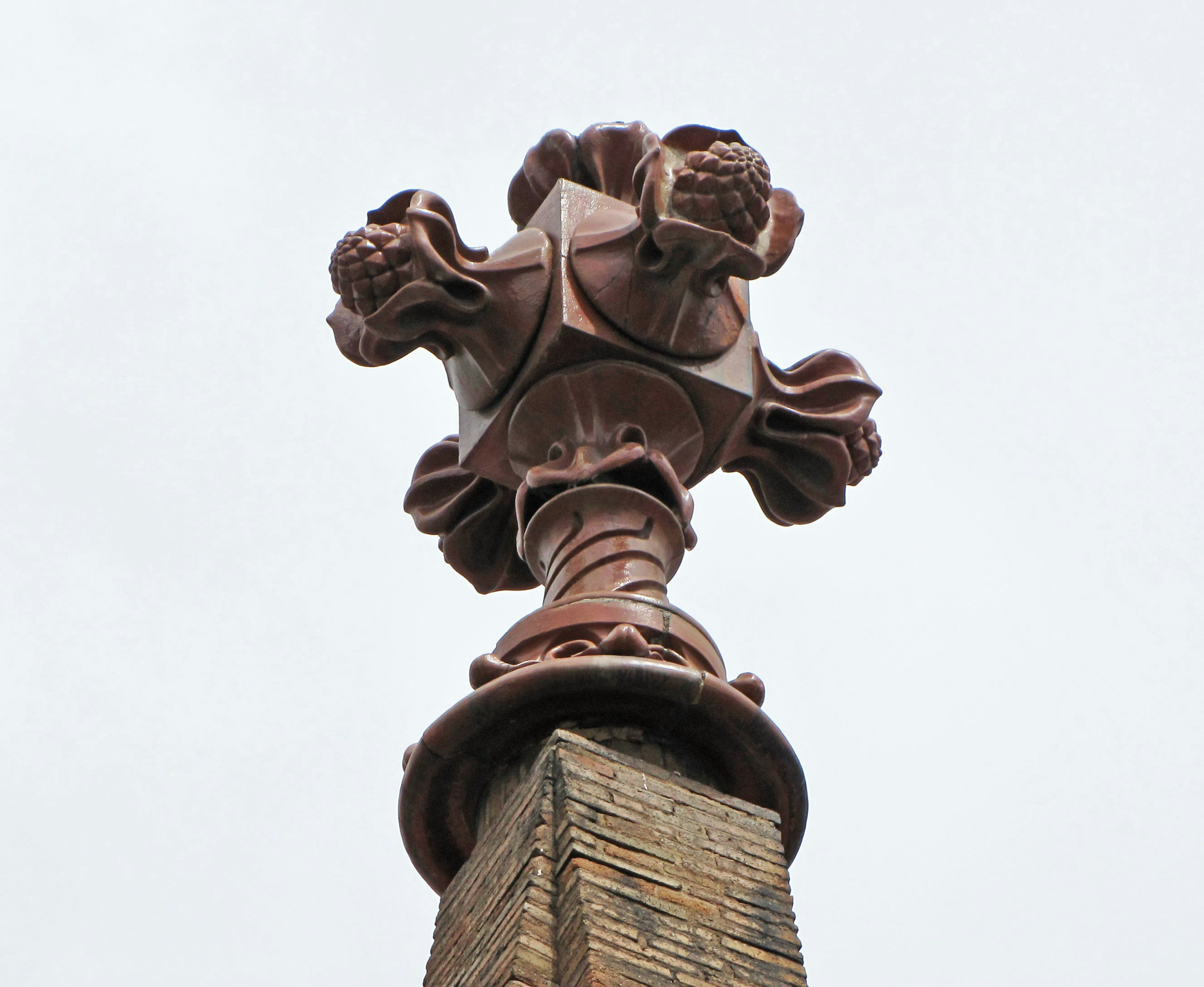 Decorative cross sculpture atop a building