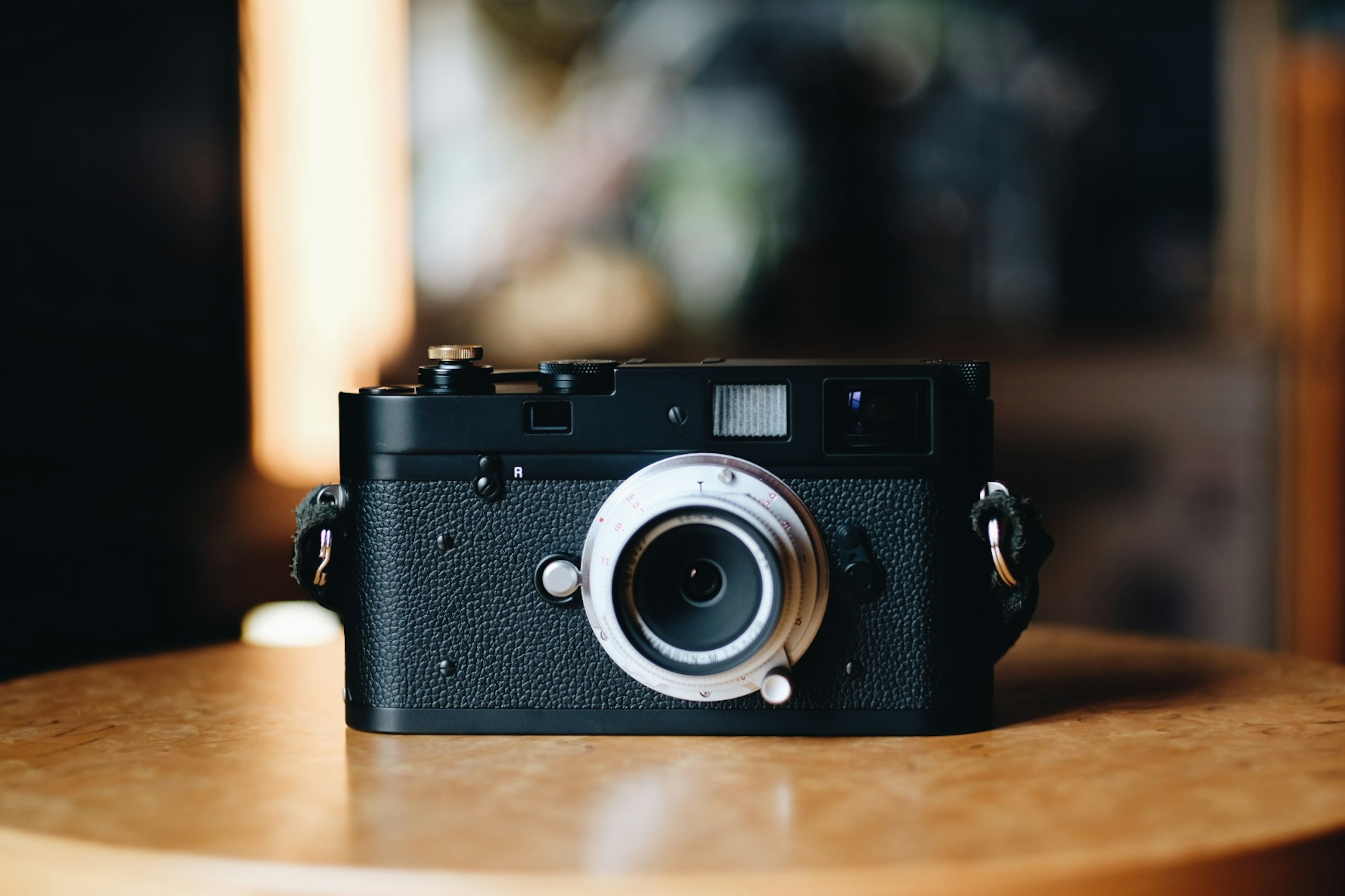 A black camera is placed on a table